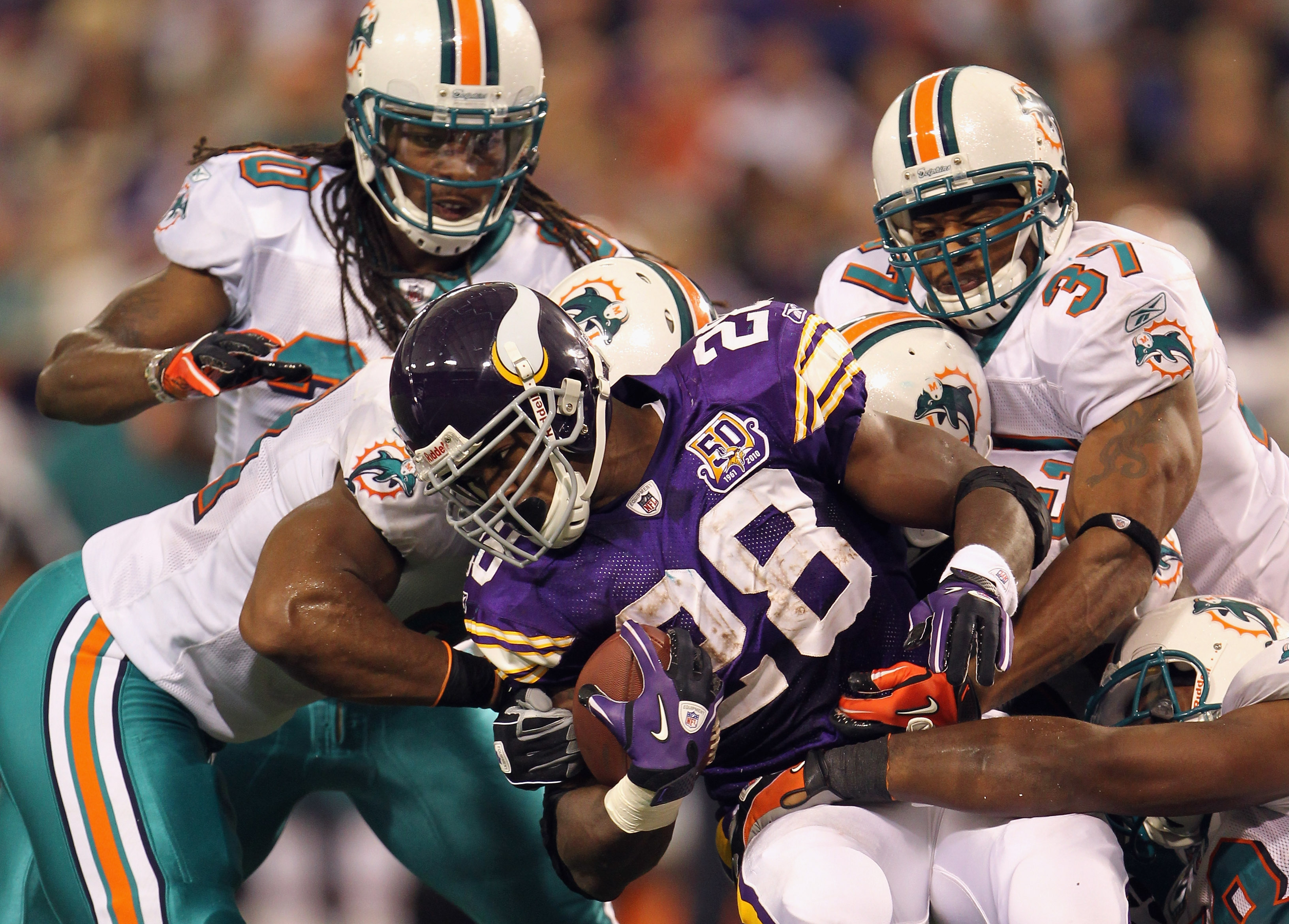 MINNEAPOLIS - SEPTEMBER 19:  Adrian Peterson #28 of the Minnesota Vikings carries the ball as he is tackled by the Miami Dolphins defense during the first half of the game on September 19, 2010 at Hubert H. Humphrey Metrodome in Minneapolis, Minnesota.  (