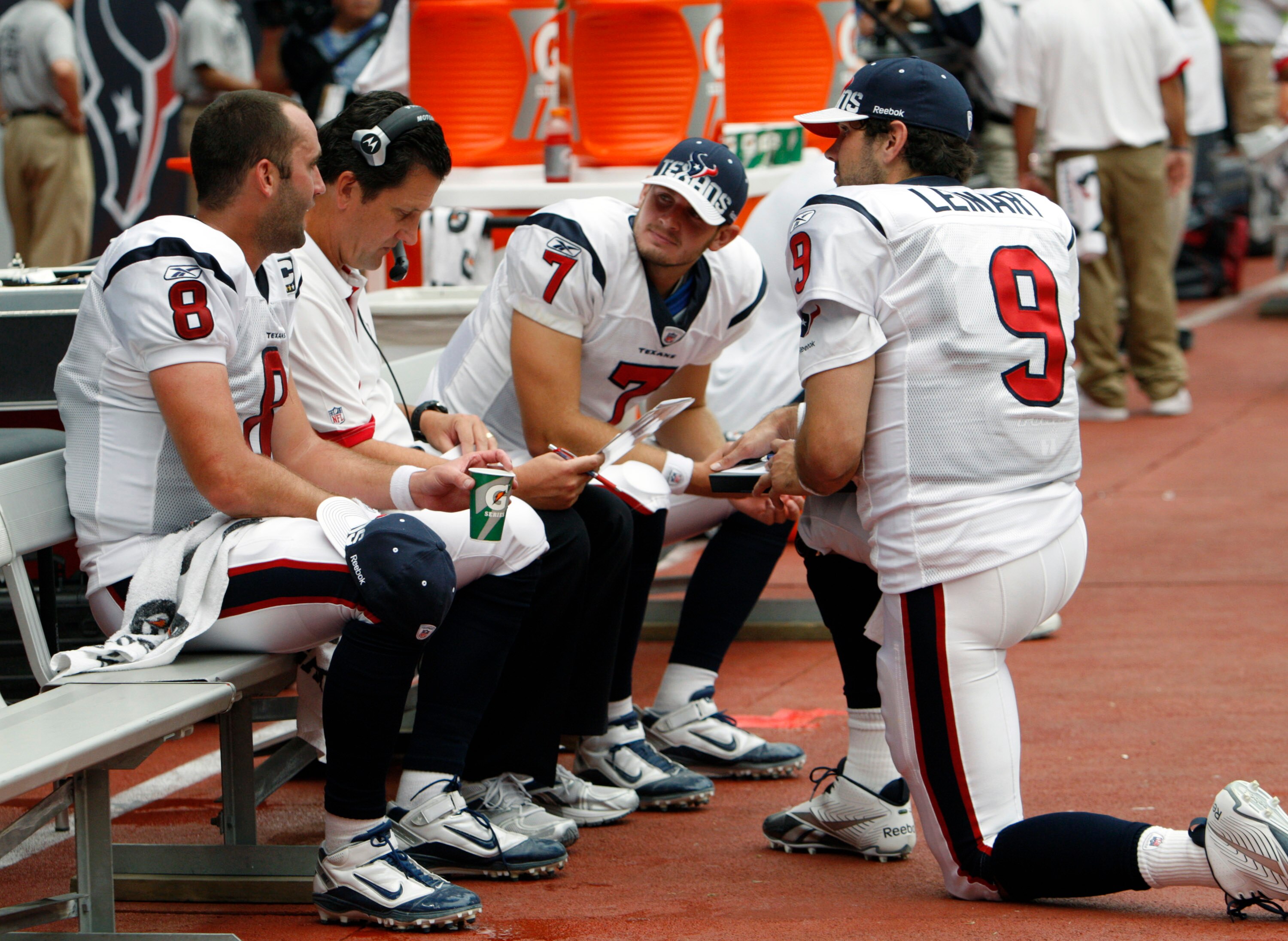HOUSTON - SEPTEMBER 12:  Quarterback  coach Frank Reich of the Houston Texans goes over plays with quarterbacks Matt Schaub #8, Dan Orlovsky #7 and Matt Leinart during the NFL season opener at Reliant Stadium on September 12, 2010 in Houston, Texas.  (Pho