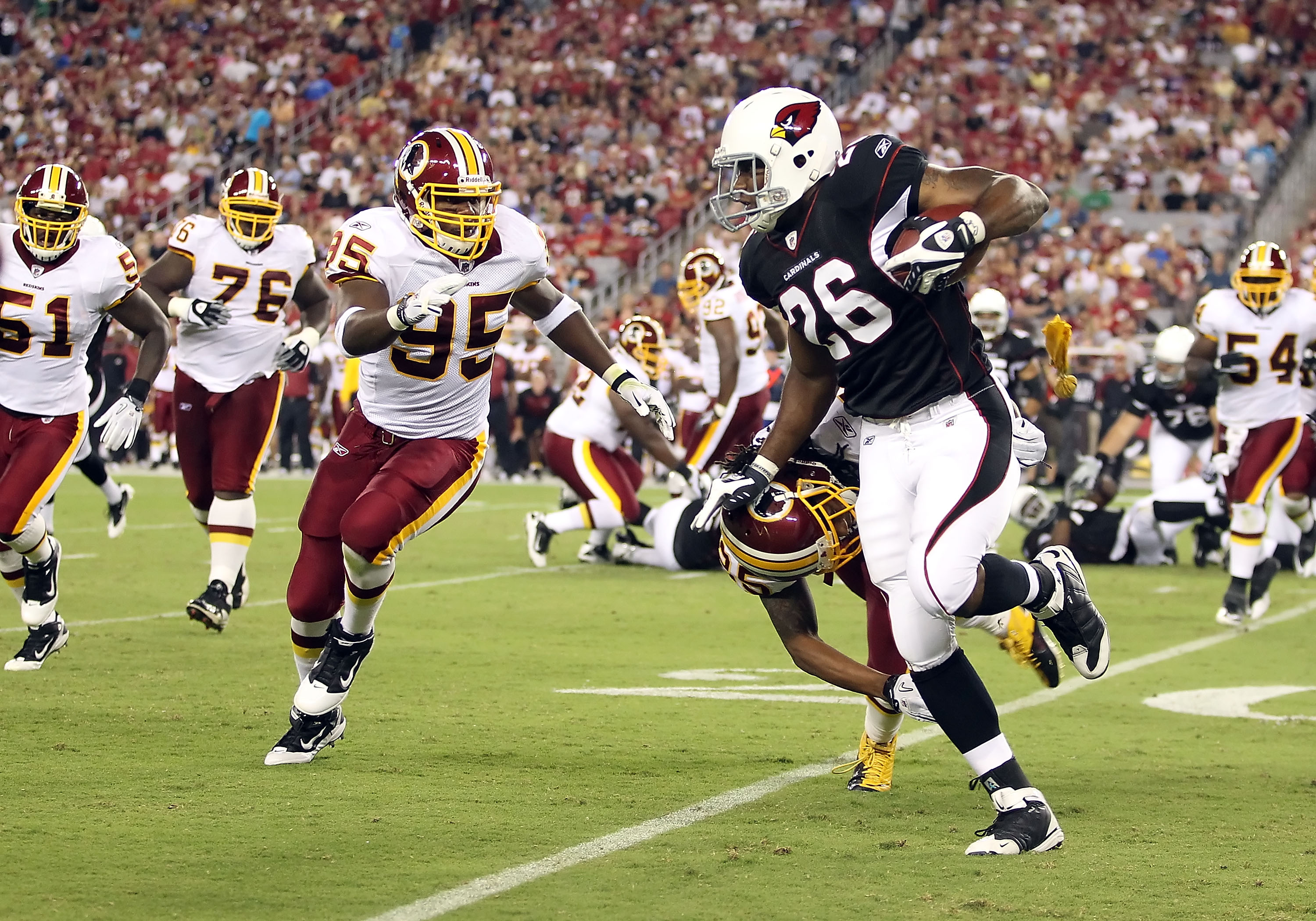GLENDALE, AZ - SEPTEMBER 02:  Runningback Beanie Wells #26 of the Arizona Cardinals rushes the football against Chris Wilson #95 and Kevin Barnes #25 of the Washington Redskins during the first quarter of the preseason NFL game at the University of Phoeni