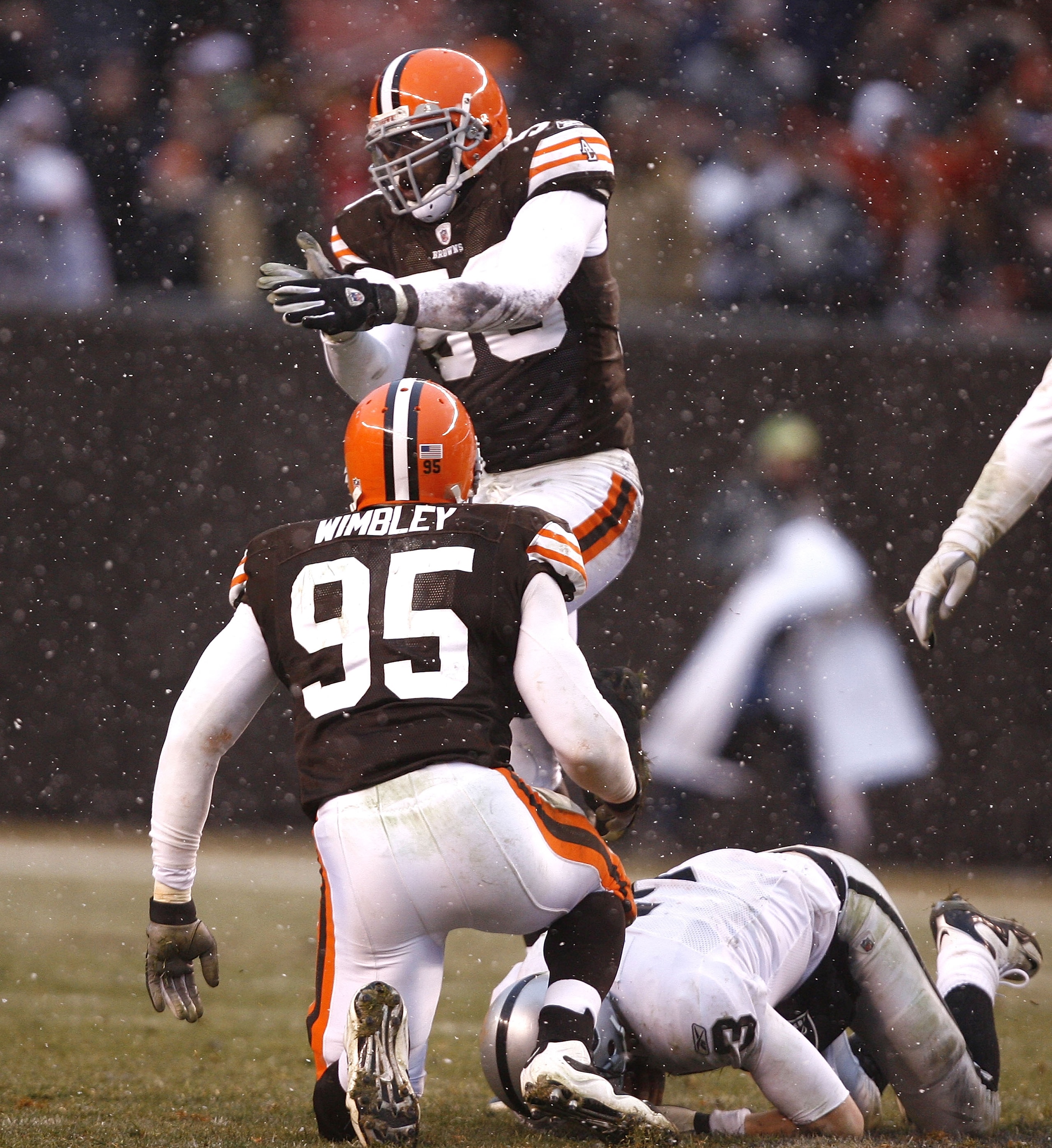 CLEVELAND - DECEMBER 27:  Marcus Benard #58 and Kamerion Wimbley #95 of the Cleveland Browns celebrate after sacking Charlie Frye #3 of the Oakland Raiders at Cleveland Browns Stadium on December 27, 2009 in Cleveland, Ohio.  (Photo by Matt Sullivan/Getty