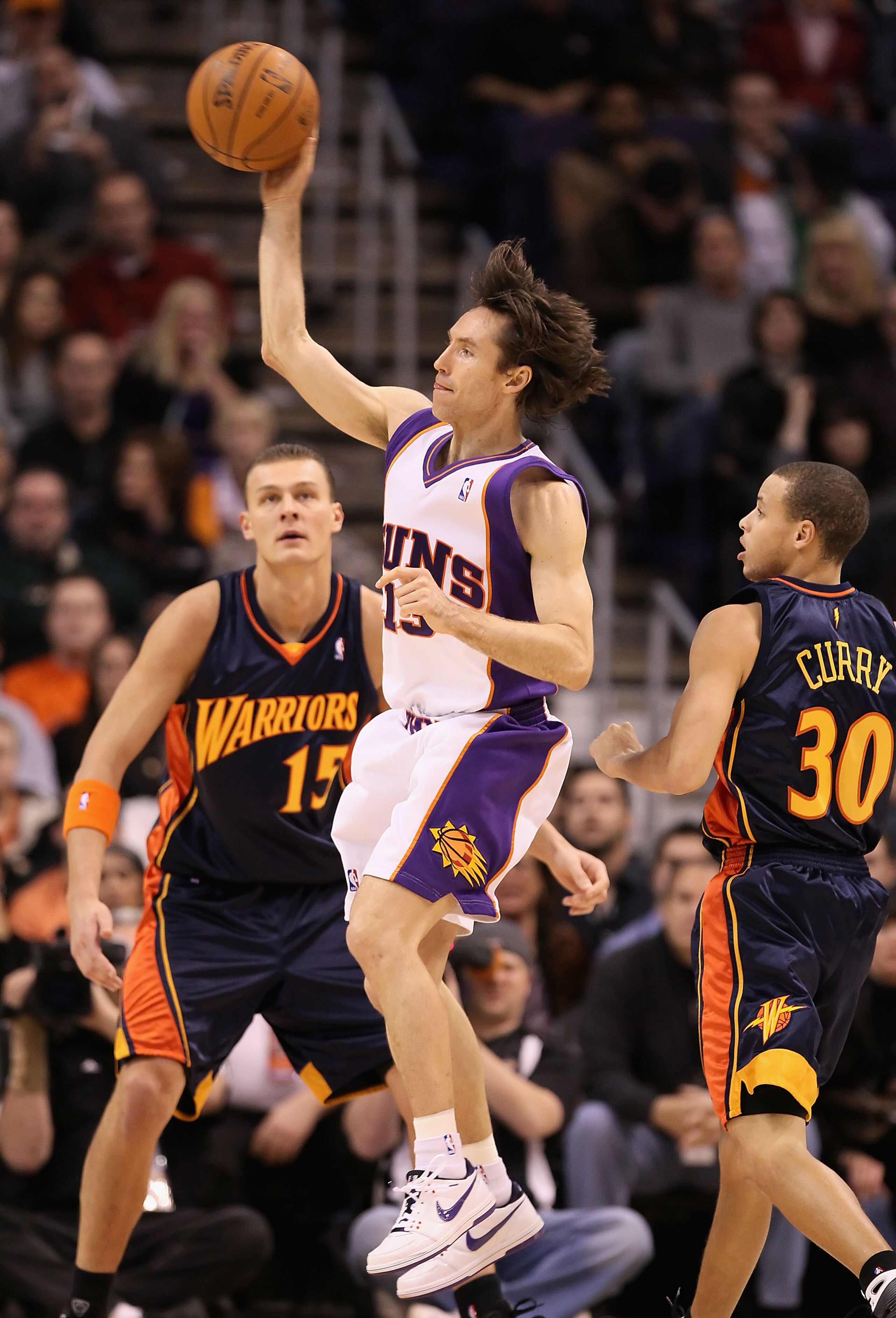 PHOENIX - JANUARY 23:  Steve Nash #13 of the Phoenix Suns passes the ball during the NBA game against the Golden State Warriors at US Airways Center on January 23, 2010 in Phoenix, Arizona. NOTE TO USER: User expressly acknowledges and agrees that, by dow