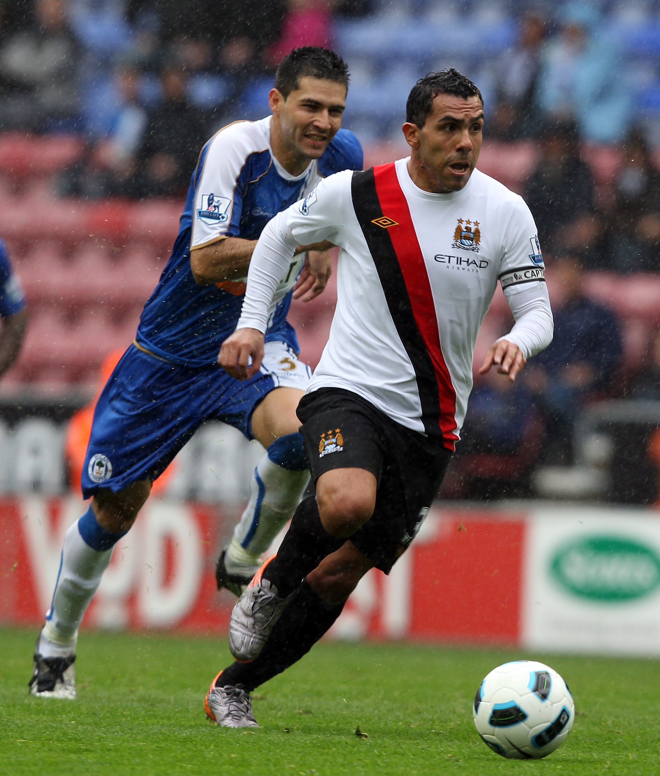 WIGAN, ENGLAND - SEPTEMBER 19:  Carlos Tevez of Manchester City bursts through to score the opening goal during the Barclays Premiership match between Wigan Athletic and Manchester City at the DW Stadium on September 19, 2010 in Wigan, England.  (Photo by
