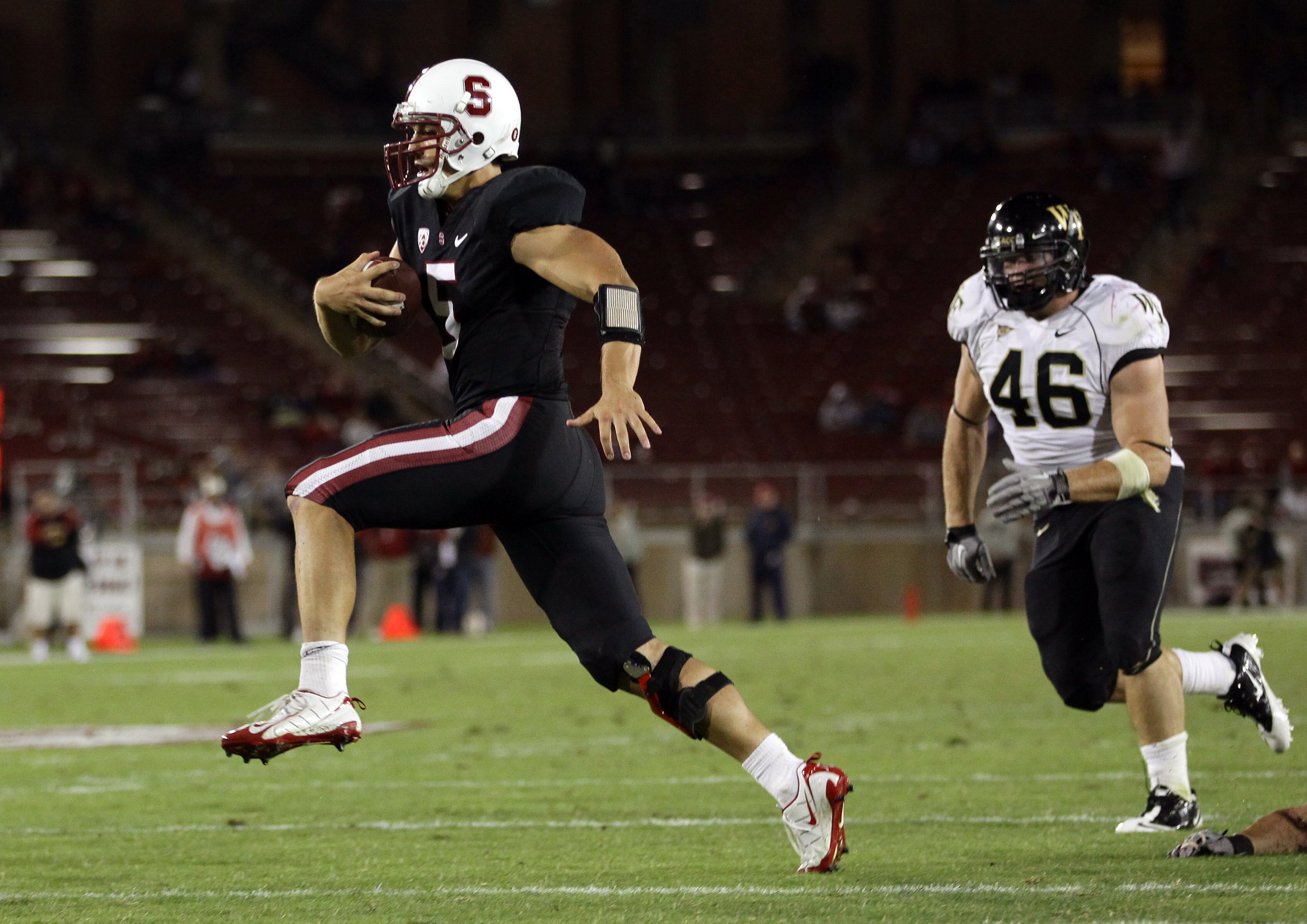 PALO ALTO, CA - SEPTEMBER 18:  Alex Loukas #5 of the Stanford Cardinal runs past Matt Woodlief #46 of the Wake Forest Demon Deacons to score a touchdown at Stanford Stadium on September 18, 2010 in Palo Alto, California.  (Photo by Ezra Shaw/Getty Images)