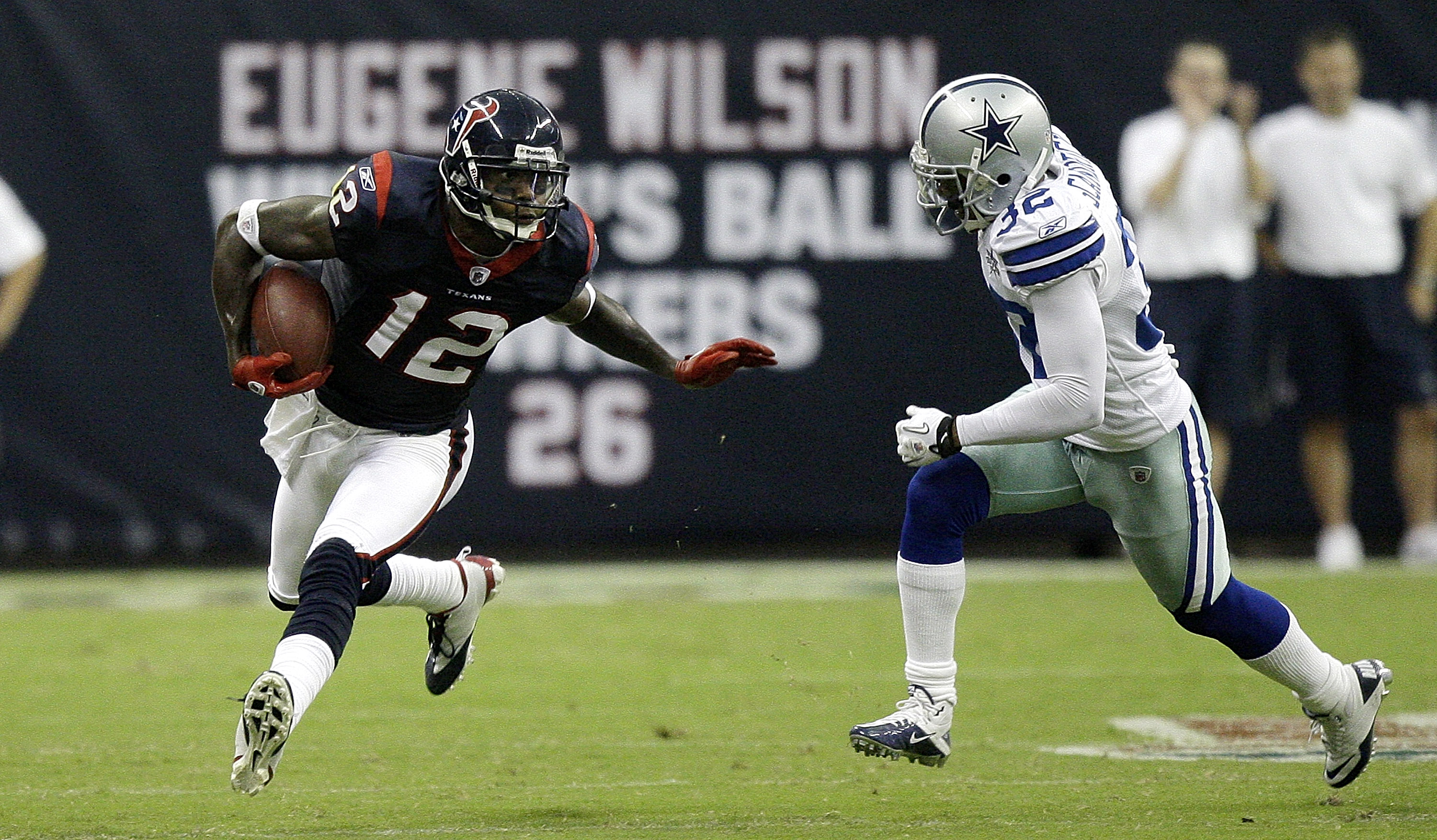 HOUSTON - AUGUST 28: Wide receiver Jacoby Jones #12 of the Houston Texans fends off Orlando Scandrick #32 in the first quarter at Reliant Stadium on August 28, 2010 in Houston, Texas. (Photo by Bob Levey/Getty Images)