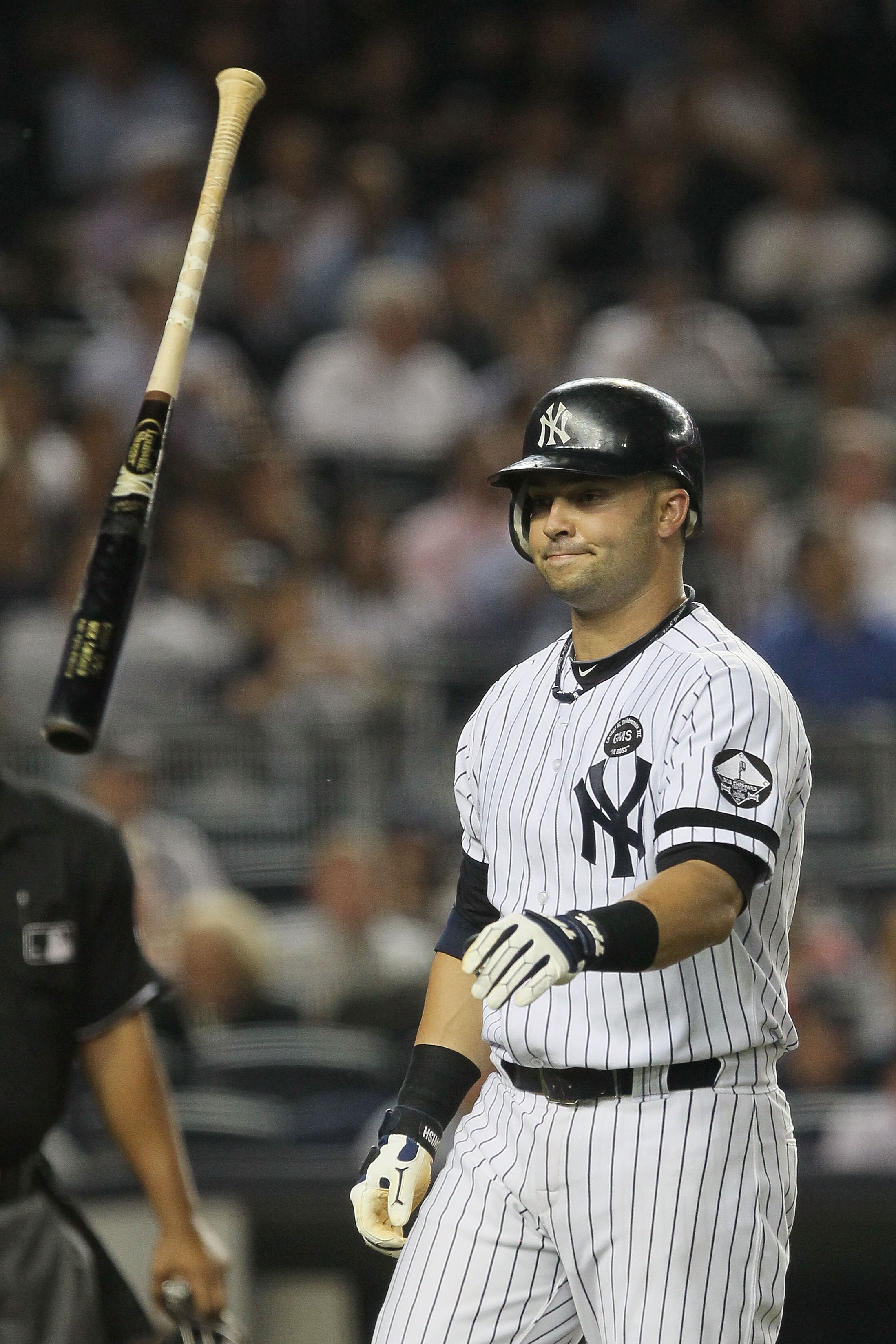 NEW YORK - SEPTEMBER 22:  Nick Swisher #33 of the New York Yankees throws his bat after striking out in the third innning against the Tampa Bay Rays during their game on September 22, 2010 at Yankee Stadium in the Bronx borough of New York City.  (Photo b