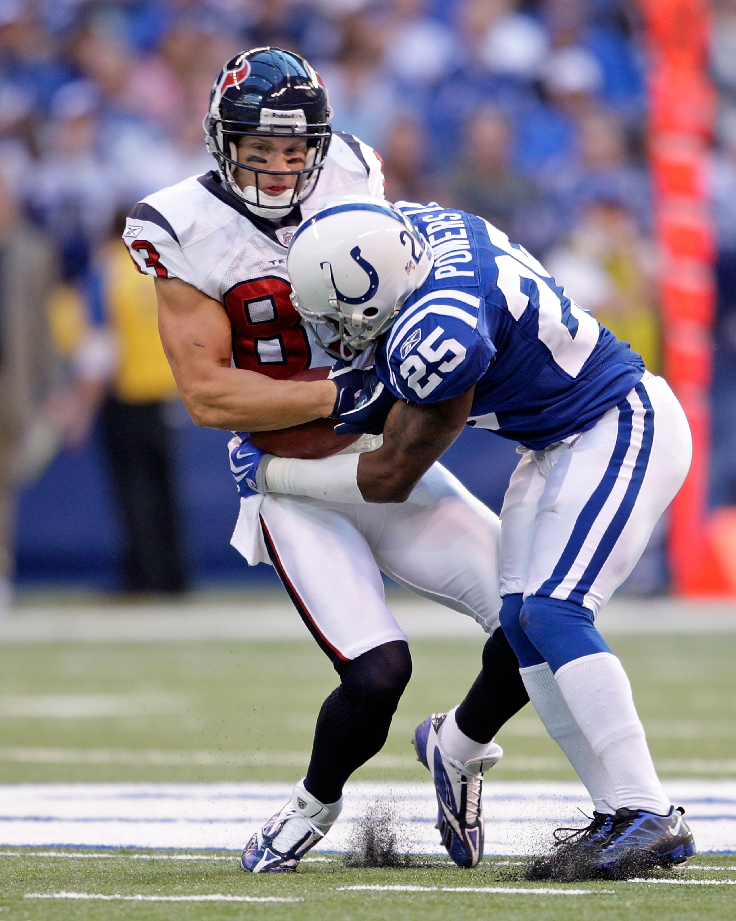 INDIANAPOLIS - NOVEMBER 8:  Kevin Walter #83 of the  Houston Texans runs with the ball while tackled by Jerraud Powers #25 of the Indianapolis Colts during the NFL game at Lucas Oil Stadium on November 8, 2009 in Indianapolis, Indiana.  The Colts defeated