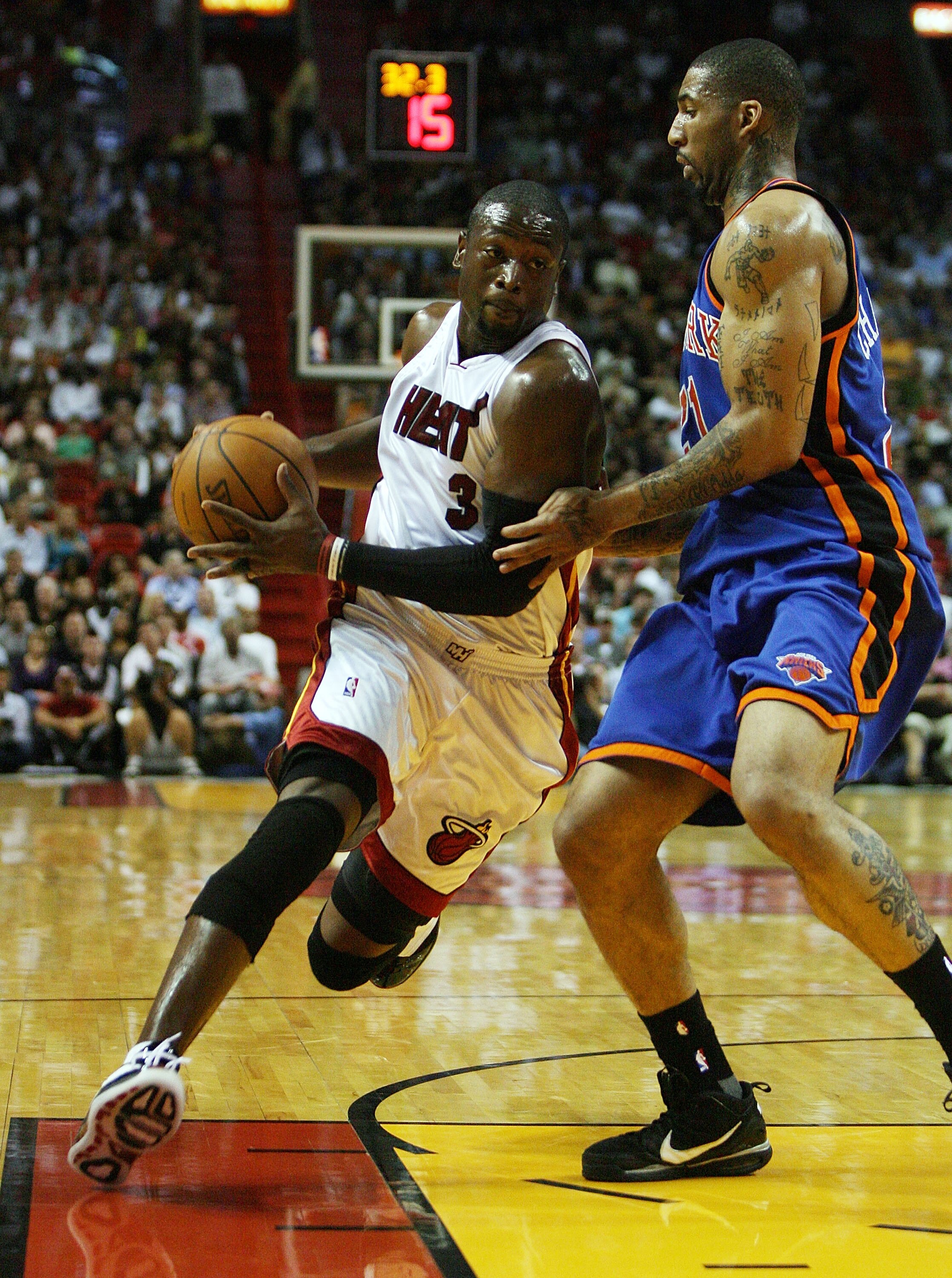 MIAMI - OCTOBER 28:  Dwyane Wade #3 of the Miami Heat drives past Wilson Chandler #21 of the New York Knicks at AmericanAirlines Arena on October 28, 2009 in Miami, Florida. NOTE TO USER: User expressly acknowledges and agrees that, by downloading and/or