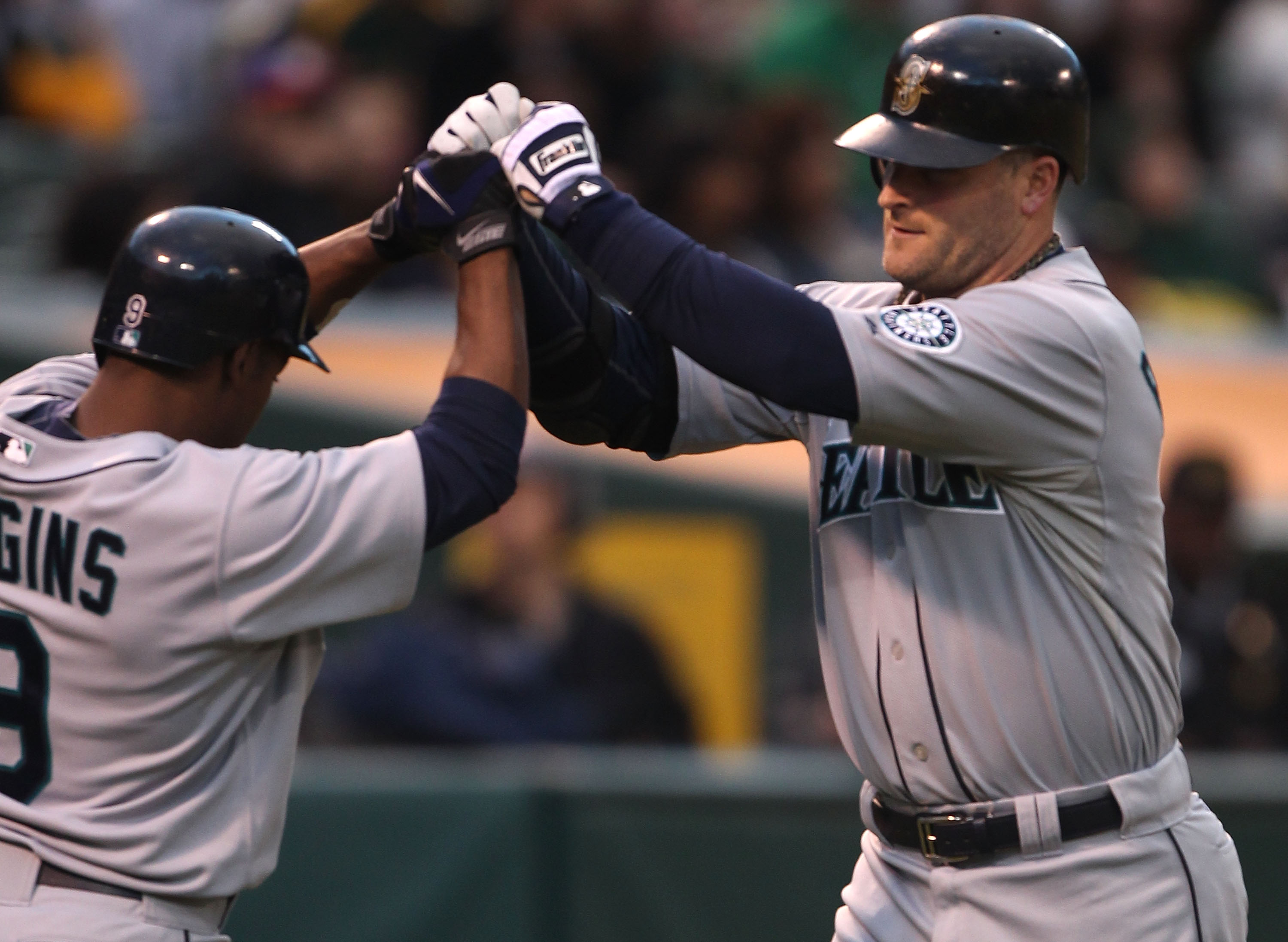 OAKLAND, CA - SEPTEMBER 08:  Russell Branyan #30 of the Seattle Mariners celebrates with Chone Figgins #9 after hitting a two run home against the Oakland Athletics in the first inning during a Major League Baseball game at the Oakland-Alameda County Coli