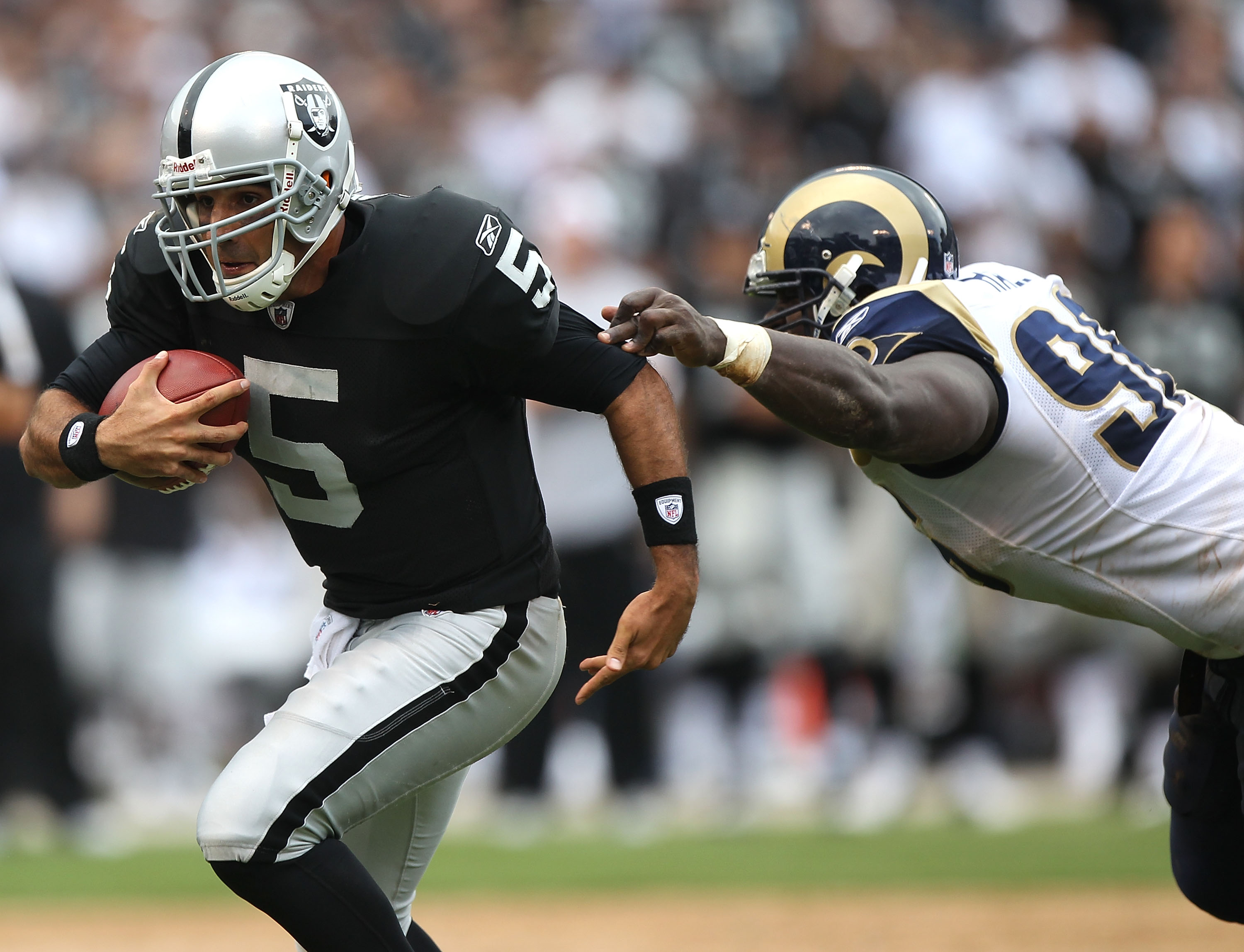 OAKLAND, CA - SEPTEMBER 19: Bruce Gradkowski #5 of the Oakland Raiders runs against James Hall #96 of the St. Louis Rams during an NFL game at Oakland-Alameda County Coliseum on September 19, 2010 in Oakland, California. (Photo by Jed Jacobsohn/Getty Im OAKLAND, CA - SEPTEMBER 19: Bruce Gradkowski #5 of the Oakland Raiders runs against James Hall #96 of the St. Louis Rams during an NFL game at Oakland-Alameda County Coliseum on September 19, 2010 in Oakland, California. (Photo by Jed Jacobsohn/Getty Im