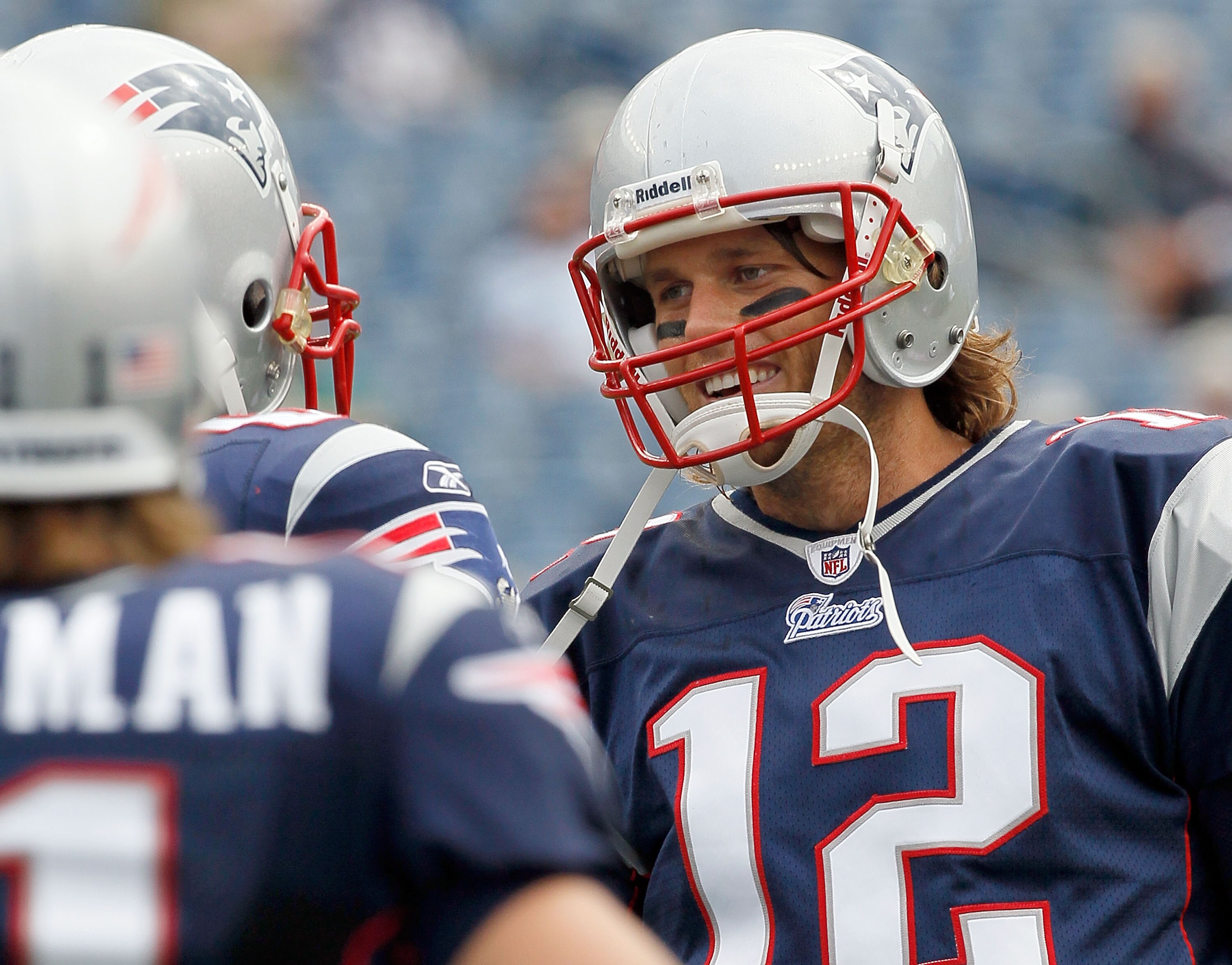 FOXBORO, MA - SEPTEMBER 26:  Tom Brady #12 of the New England Patriots talks to teammates during pregame drills before a game against the Buffalo Bills at Gillette Stadium on September 26, 2010 in Foxboro, Massachusetts. (Photo by Jim Rogash/Getty Images)
