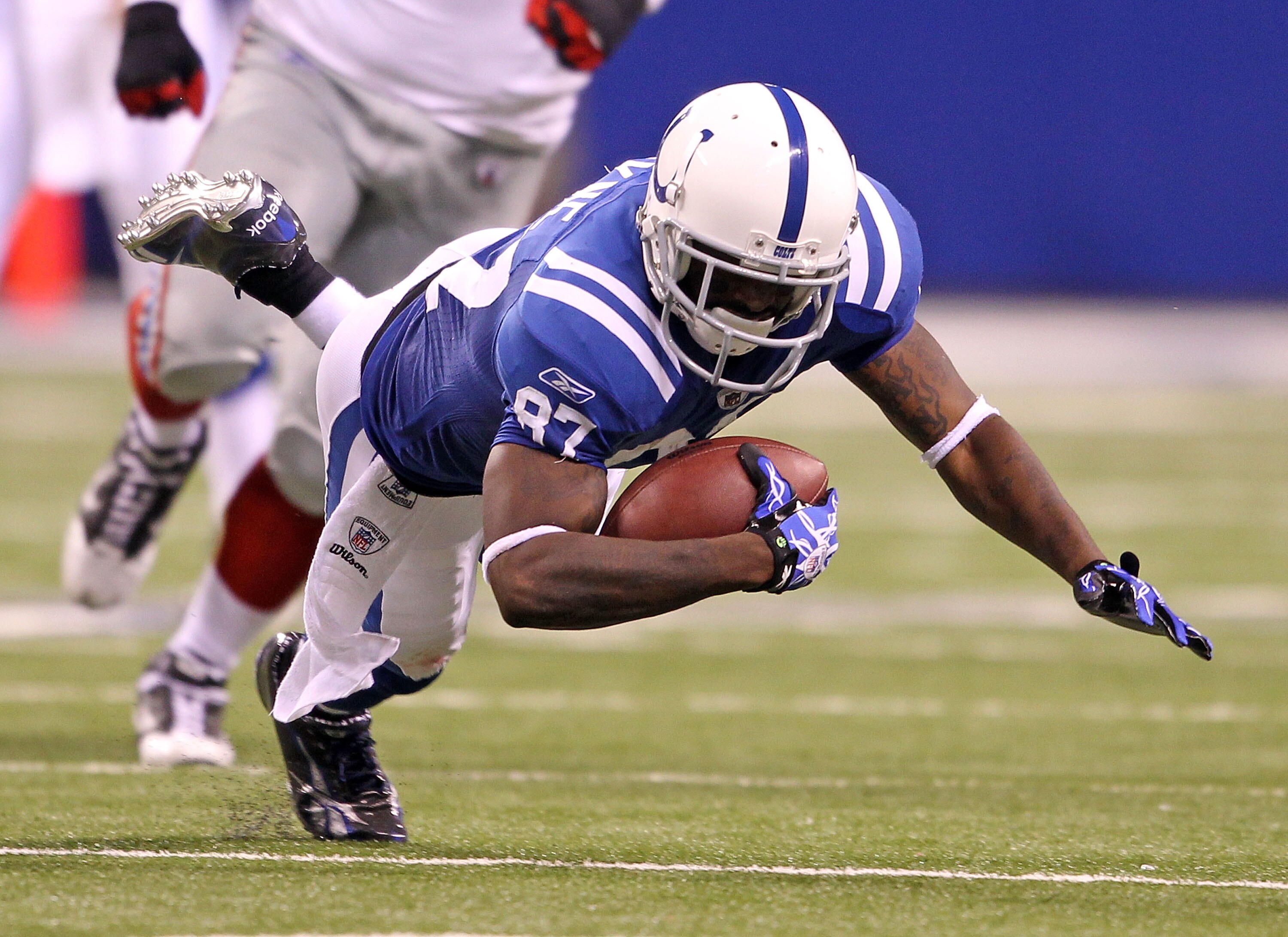 INDIANAPOLIS - SEPTEMBER 19:  Reggie Wayne #87 of the Indianapolis Colts dives for extra yards during the NFL game against the New York Giants  at Lucas Oil Stadium on September 19, 2010 in Indianapolis, Indiana.  (Photo by Andy Lyons/Getty Images)