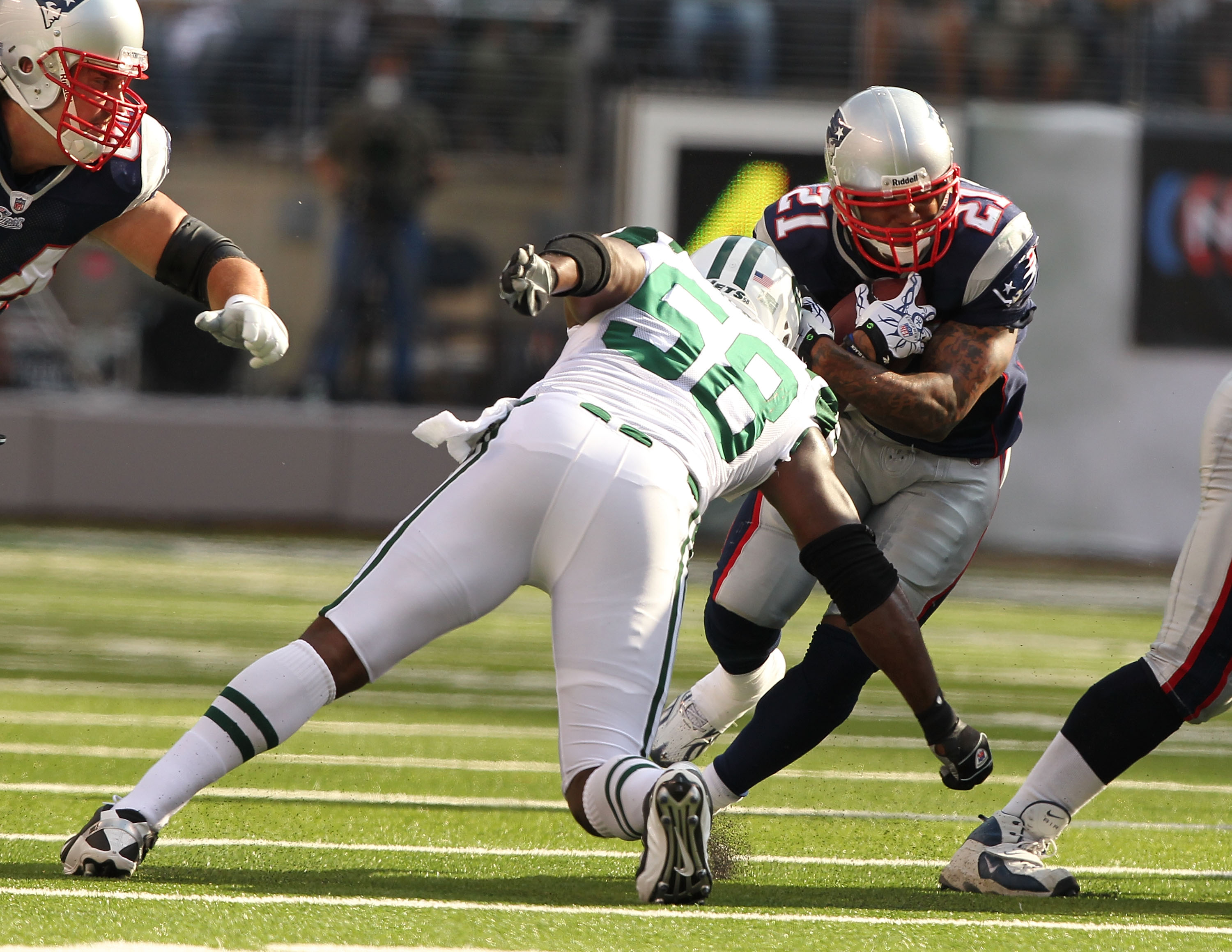 EAST RUTHERFORD, NJ - SEPTEMBER 19:  Bryan Thomas #58 of the New York Jets tackles Fred Taylor #21 of the New England Patriots during their  game on September 19, 2010 at the New Meadowlands Stadium  in East Rutherford, New Jersey.  (Photo by Al Bello/Get