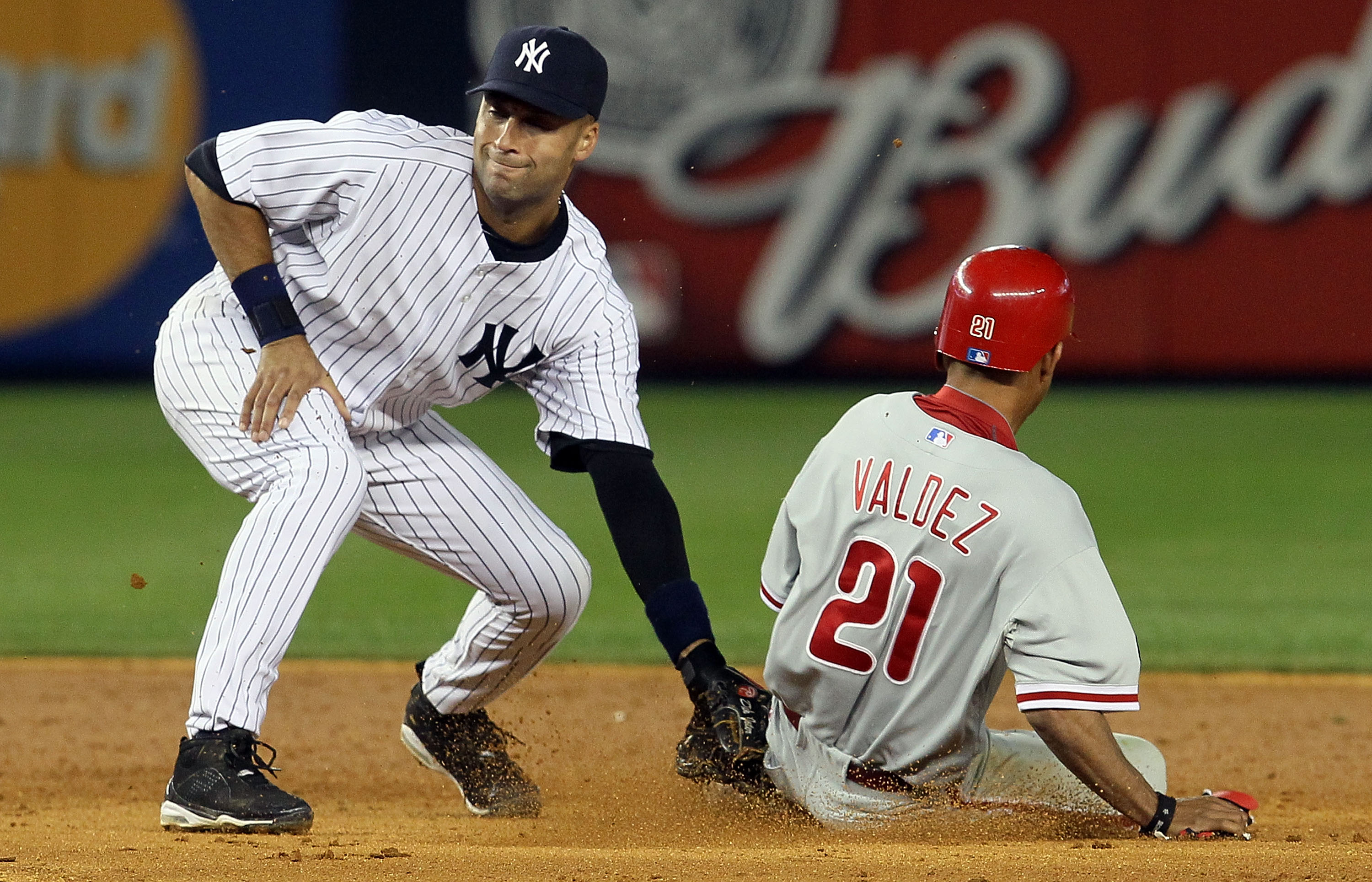 NEW YORK - JUNE 17:  Derek Jeter #2 of the New York Yankees is late with the tag as Wilson Valdez #21 of the Philadelphia Phillies steals second base in the ninth inning on June 17, 2010 at Yankee Stadium in the Bronx borough of New York City. The Phillie