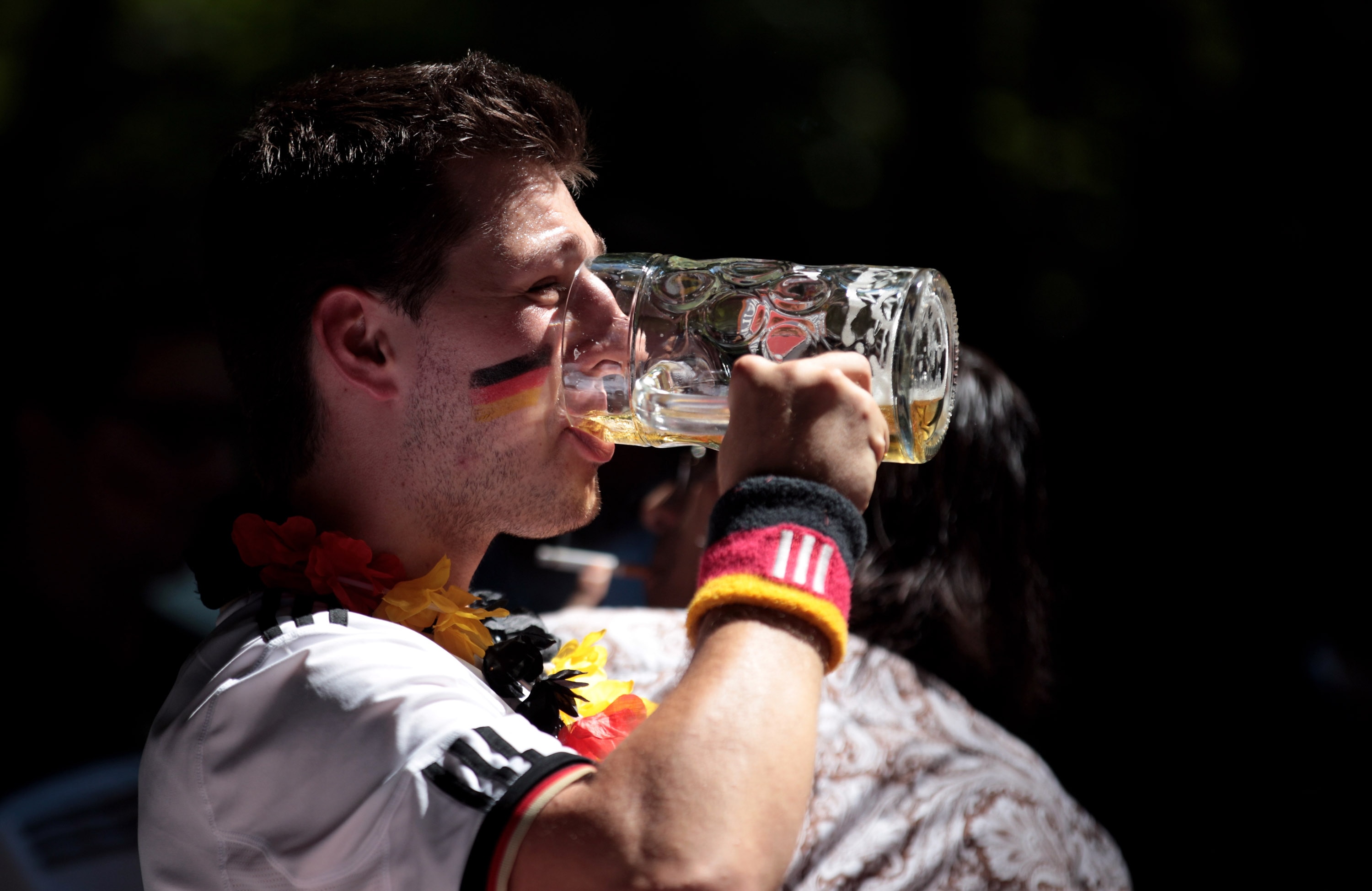 MUNICH - JULY 03:  A supporter of the German football team drinks a beer as he watches the 2010 FIFA World Cup quarter final match between Germany and Argentina at a beer garden on July 3, 2010 in Munich, Germany.  (Photo by Miguel Villagran/Getty Images)