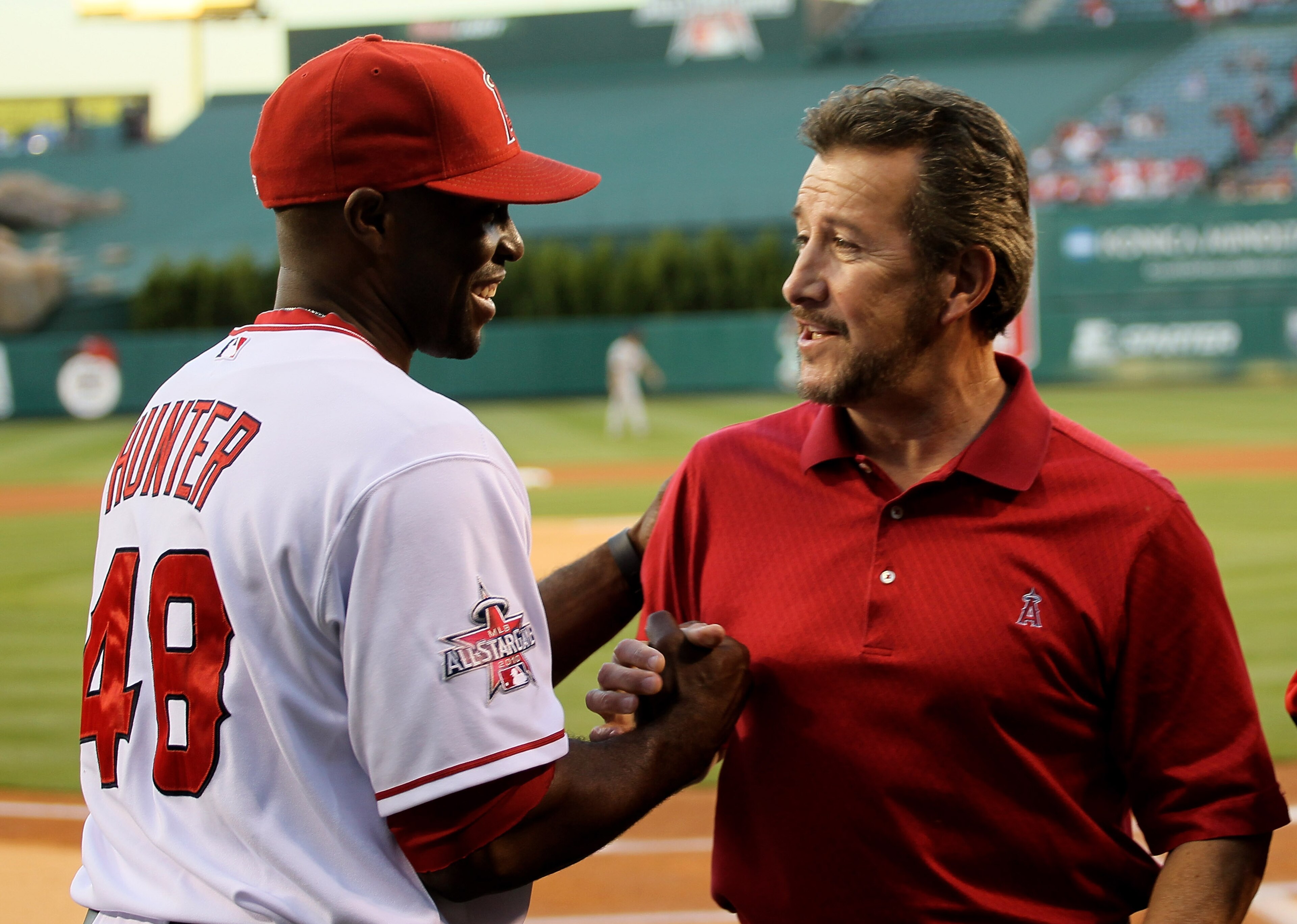 ANAHEIM, CA - APRIL 08:  Torii Hunter #48 of the Los Angeles Angels of Anaheim is greeted by team owner Arturo Moreno as Hunter receives his 2009 Silver Slugger award before the game with the Minnesota Twins on April 8, 2010 at Angel Stadium in Anaheim, C