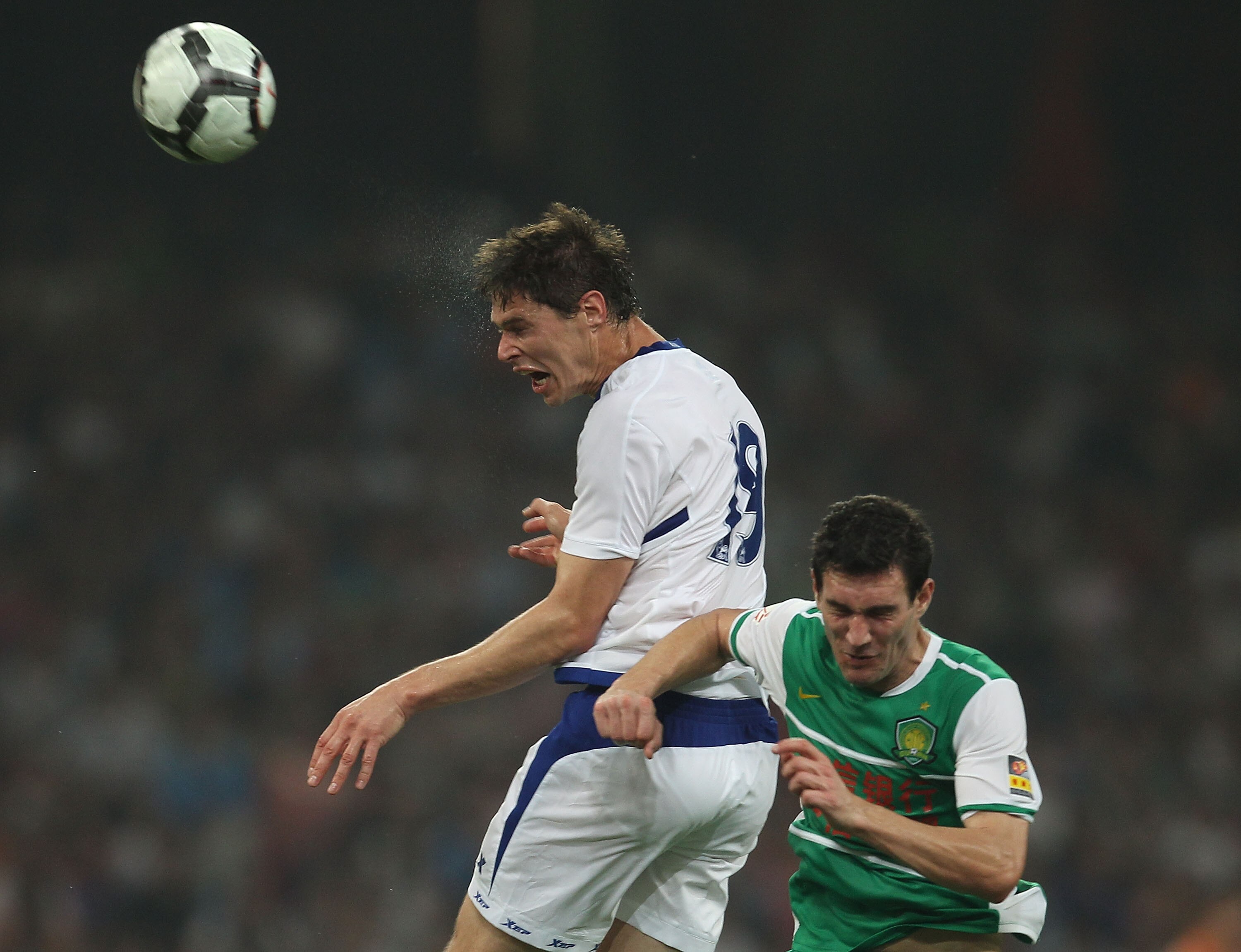 BEIJING - JULY 21: Nikola Zigic of Birmingham City heads the ball during the 2010/11 pre-season friendly match between Beijing Guoan and Birmingham City at National Stadium as part of Birmingham City's China pre-season tour of China and Hong Kong on July BEIJING - JULY 21: Nikola Zigic of Birmingham City heads the ball during the 2010/11 pre-season friendly match between Beijing Guoan and Birmingham City at National Stadium as part of Birmingham City's China pre-season tour of China and Hong Kong on July