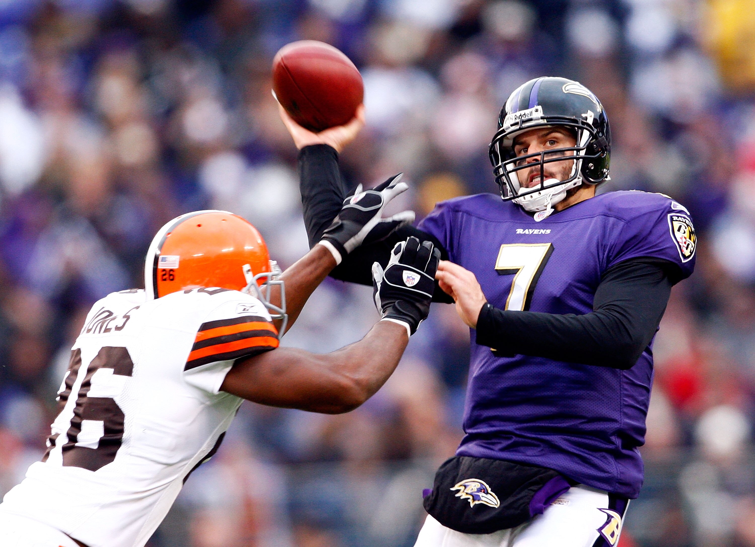 BALTIMORE - NOVEMBER 18:  Quarterback Kyle Boller #7 of the Baltimore Ravens passes as he is hit by Sean Jones #26 of the Cleveland Browns during the second half of the game at M&T Bank Stadium November 18, 2007 in Baltimore, Maryland.  (Photo by Jamie Sq