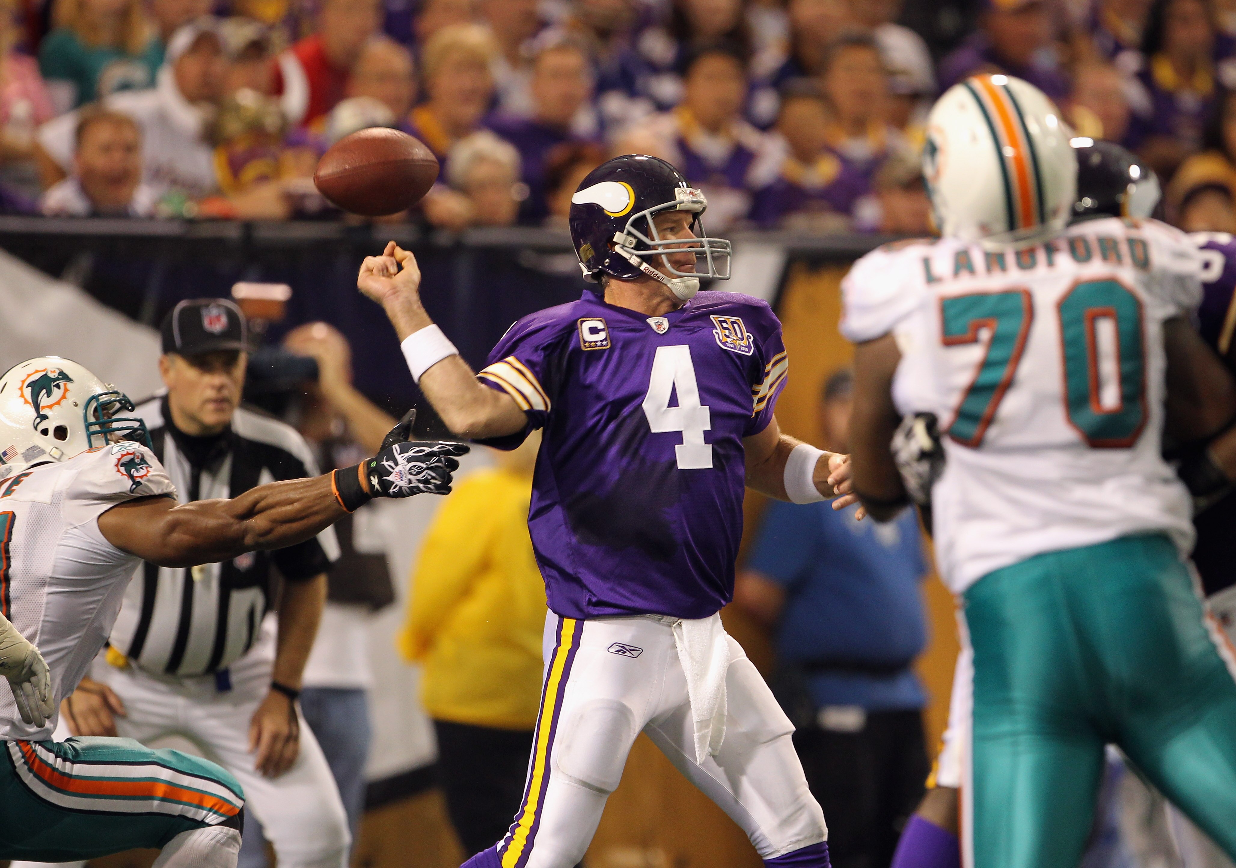 MINNEAPOLIS - SEPTEMBER 19:  Linebacker Cameron Wake #91 of the Miami Dolphins forces the ball loose as quarterback Brett Favre #4 of the Minnesota Vikings drops back to pass during the game on September 19, 2010 at Hubert H. Humphrey Metrodome in Minneap