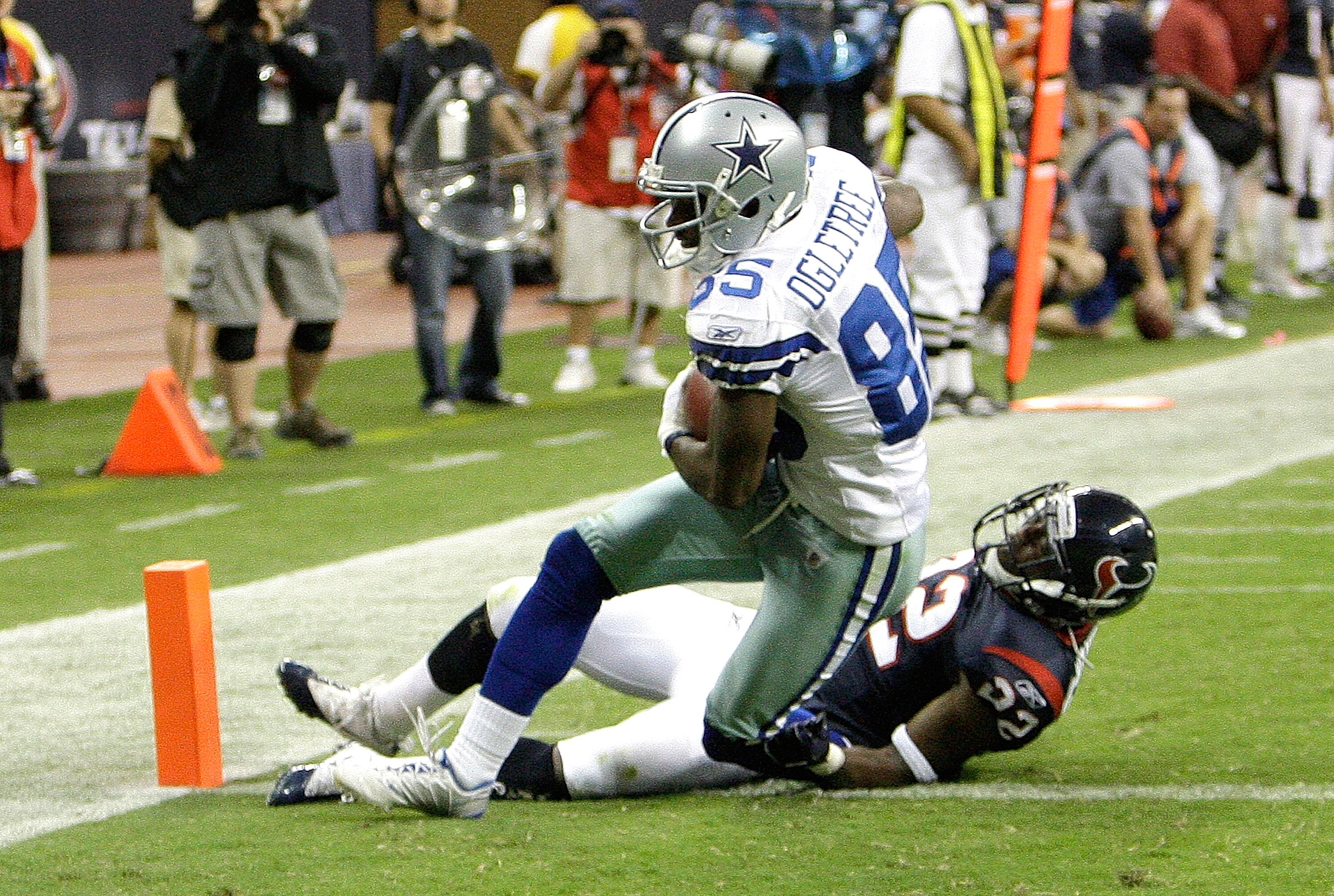 HOUSTON - AUGUST 28: Wide receiver Kevin Ogletree #85 of the Dallas Cowboys his tackled by cornerback Sherrick McManis #22 of the Houston Texans as he scores in the fourth quarter at Reliant Stadium on August 28, 2010 in Houston, Texas. Houston won 23-7.