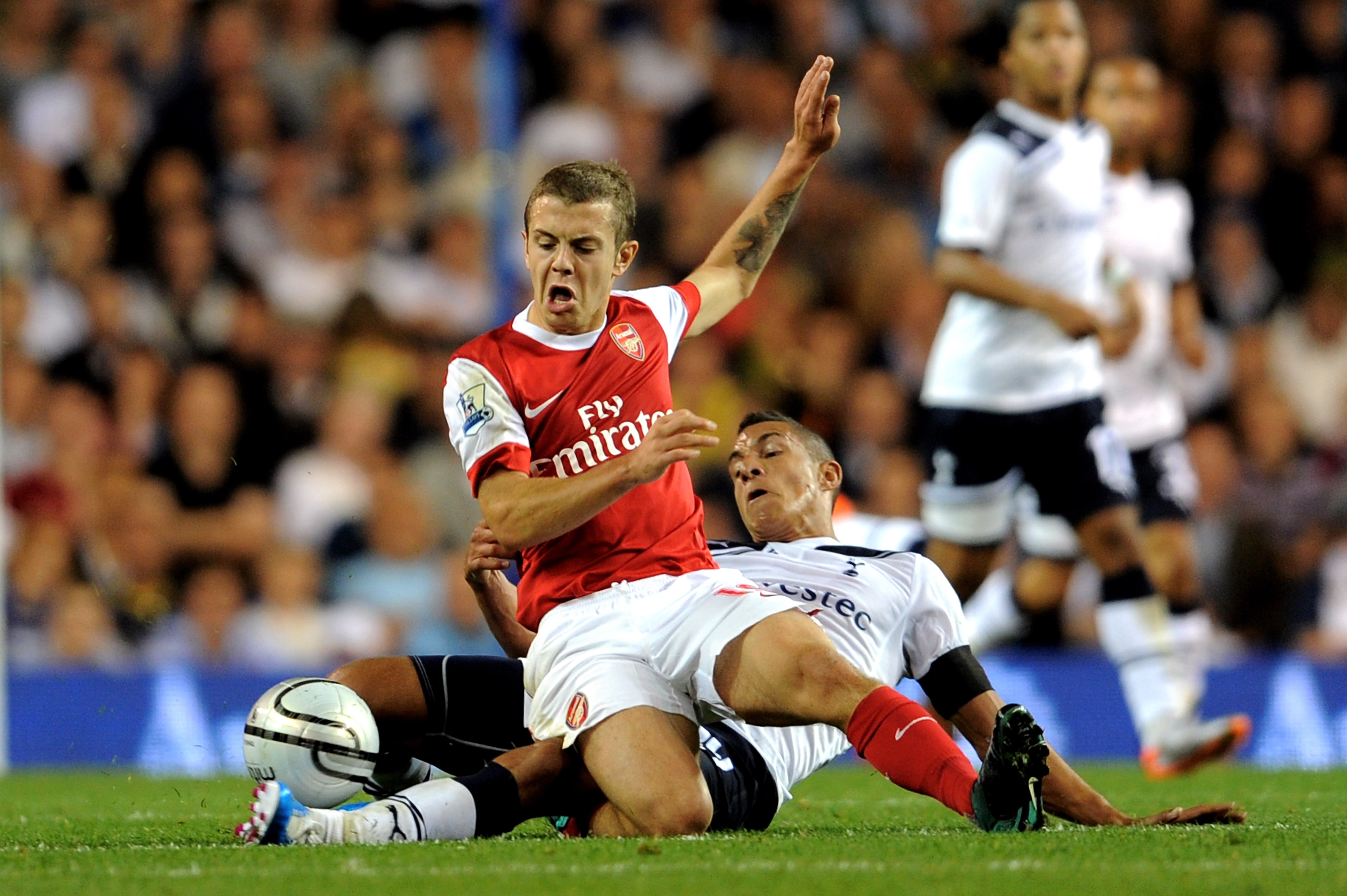 LONDON, ENGLAND - SEPTEMBER 21:  Jack Wilshere of Arsenal is tackled by Jake Livermore of Spurs during the Carling Cup third round match between Tottenham Hotspur and Arsenal at White Hart Lane on September 21, 2010 in London, England.  (Photo by Michael