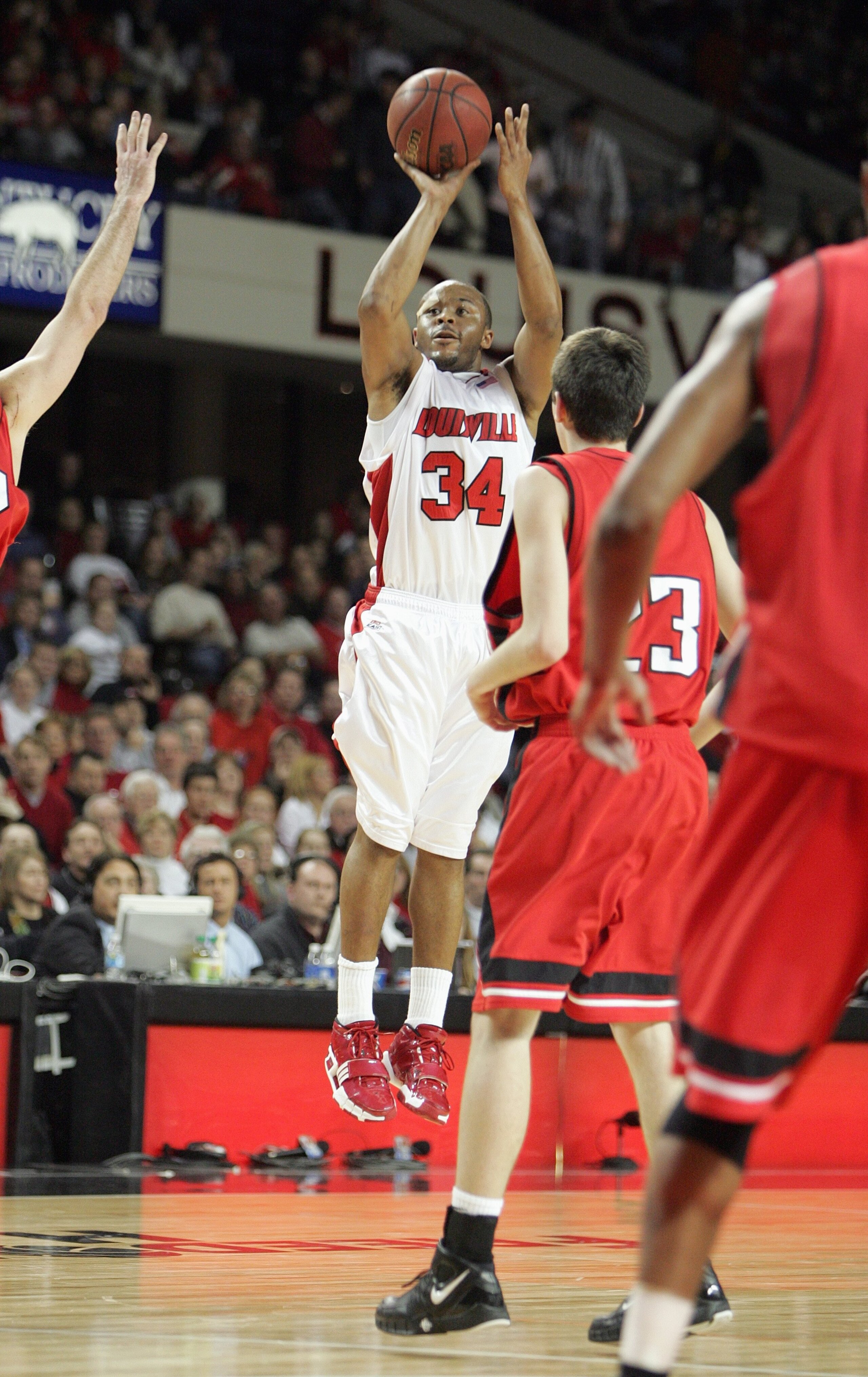 LOUISVILLE, KY - DECEMBER 27: Jerry Smith #34  of the Louisville Cardinals makes a jumpshot against Matt Janning #23 of the Northeastern Huskies on December 27, 2006 at Freedom Hall in Louisville, Kentucky. (Photo by Andy Lyons/Getty Images)