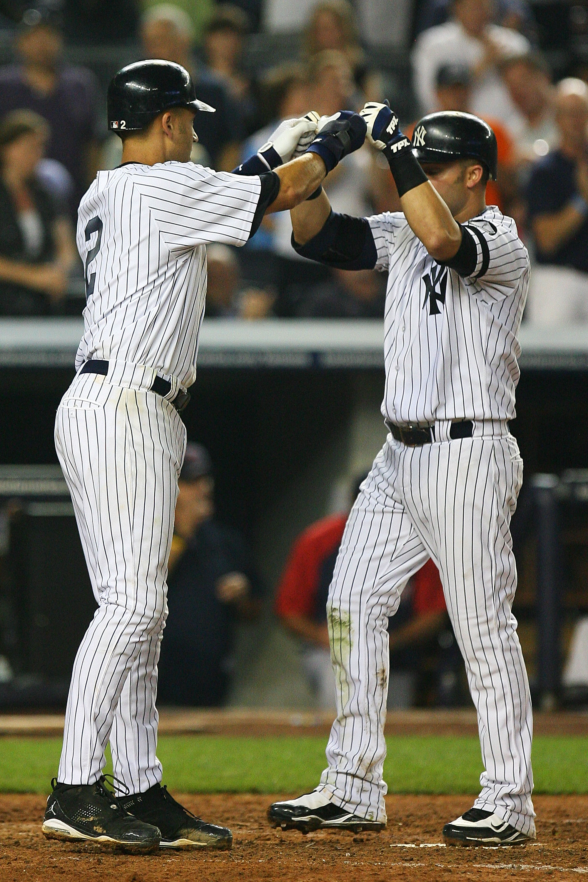 NEW YORK - SEPTEMBER 24: Derek Jeter #2 (L) of the New York Yankees celebrates with Nick Swisher #33 after Swisher hit a two run home run in the seventh inning against the Boston Red Sox on September 24, 2010 at Yankee Stadium in the Bronx borough of New NEW YORK - SEPTEMBER 24: Derek Jeter #2 (L) of the New York Yankees celebrates with Nick Swisher #33 after Swisher hit a two run home run in the seventh inning against the Boston Red Sox on September 24, 2010 at Yankee Stadium in the Bronx borough of New