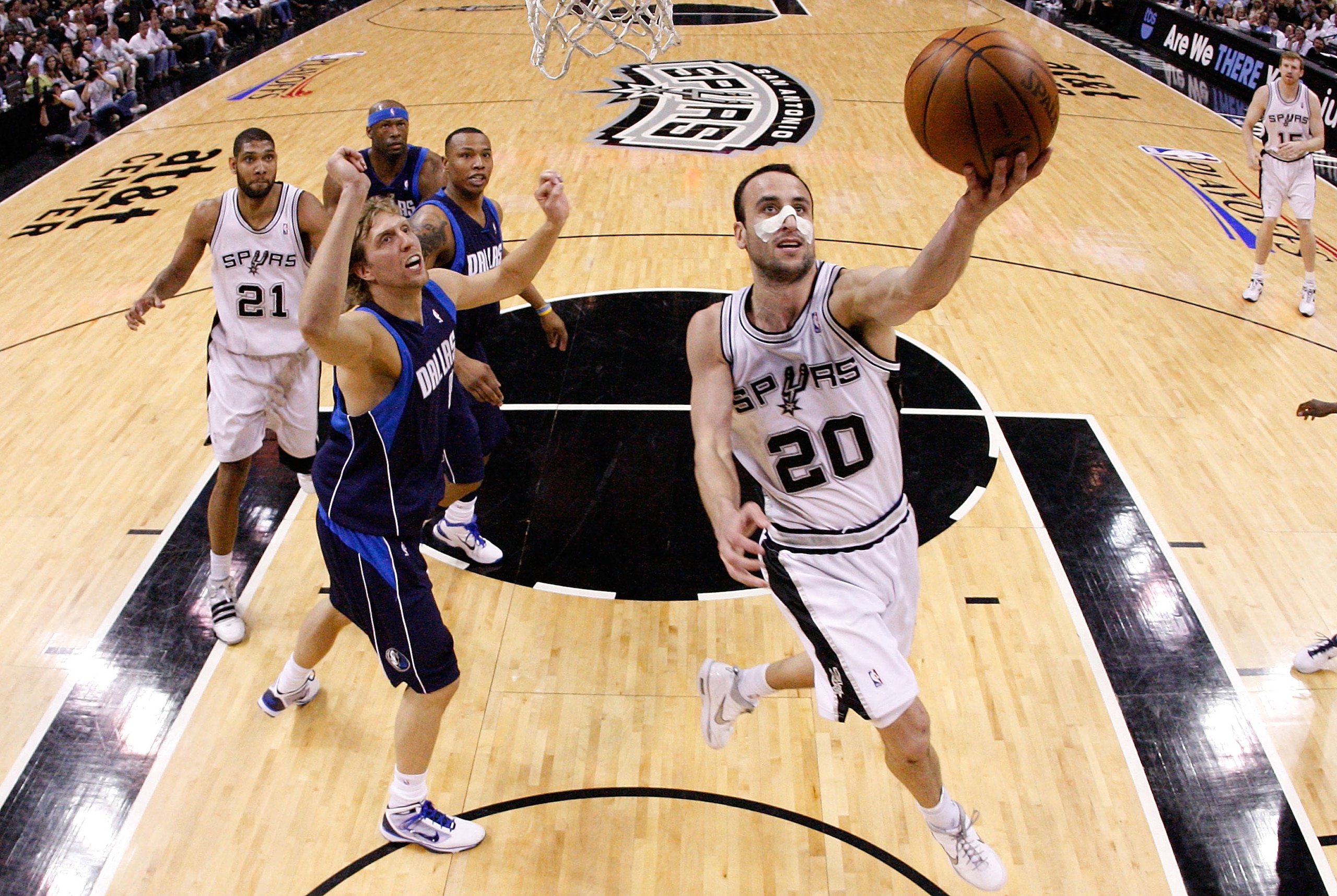 SAN ANTONIO - APRIL 29:  Guard Manu Ginobili #20 of the San Antonio Spurs takes a shot against Dirk Nowitzki #41 of the Dallas Mavericks in Game Six of the Western Conference Quarterfinals during the 2010 NBA Playoffs at AT&T Center on April 29, 2010 in S