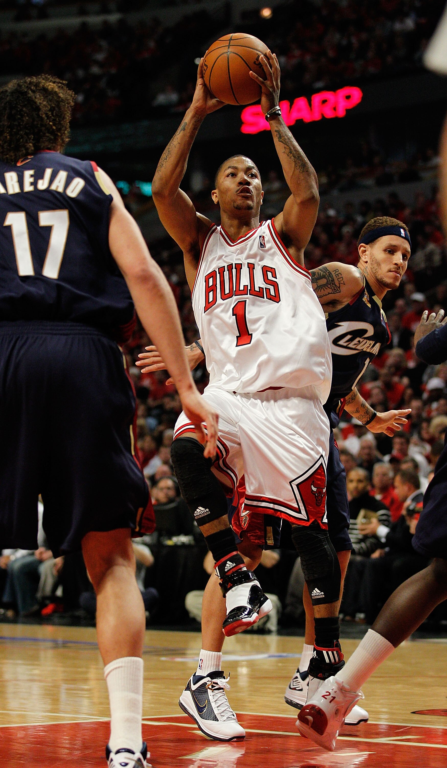 CHICAGO - APRIL 22: Derrick Rose #1 of the Chicago Bulls puts up a shot between Delonte West #13 and Anderson Varejao #17 of the Cleveland Cavaliers in Game Three of the Eastern Conference Quarterfinals during the 2010 NBA Playoffs at the United Center on