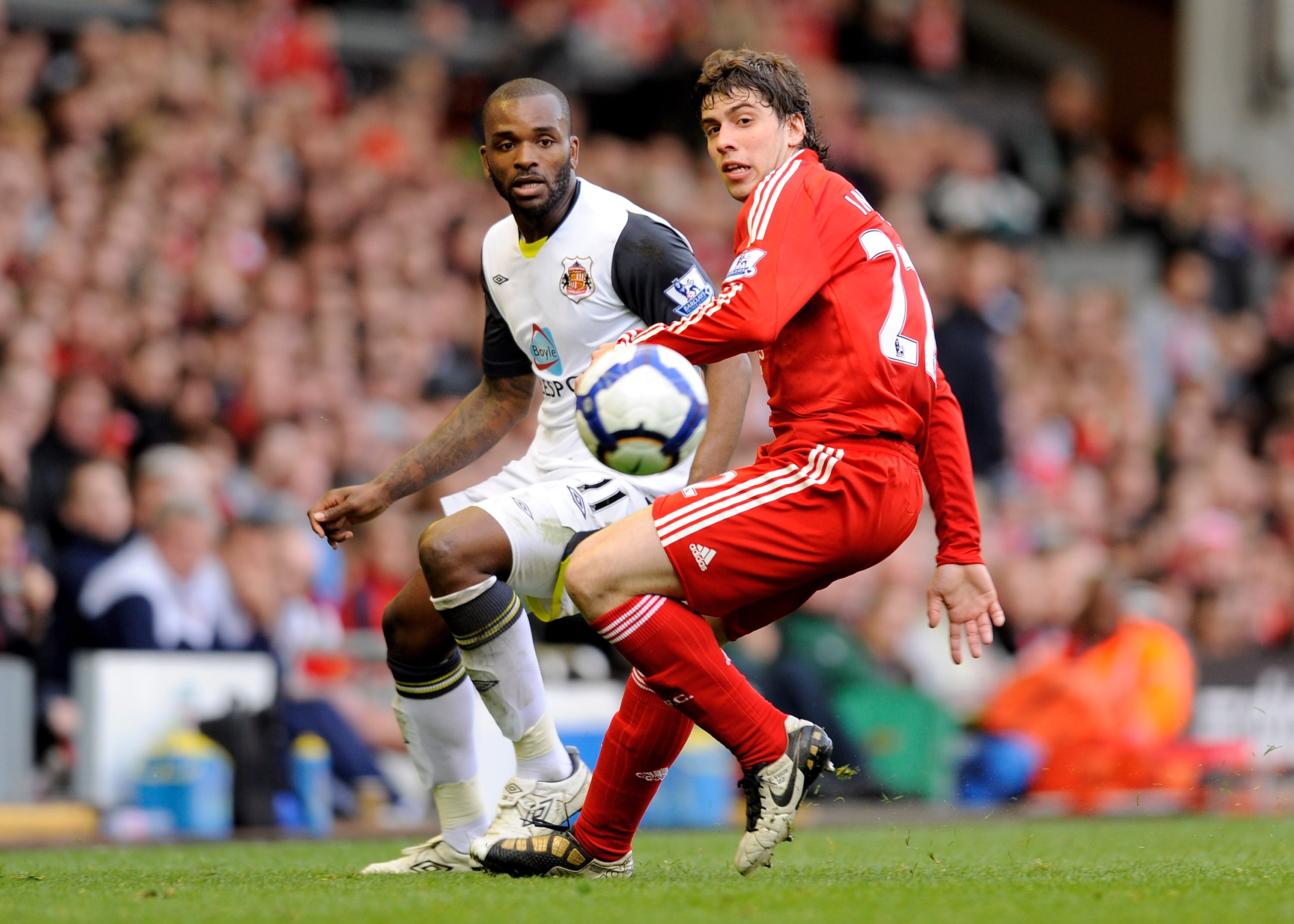 LIVERPOOL, ENGLAND - MARCH 28:  Darren Bent of Sunderland competes for the ball with Emiliano Insua of Liverpool during the Barclays Premier League match between Liverpool and Sunderland at Anfield on March 28, 2010 in Liverpool, England. (Photo by Michae