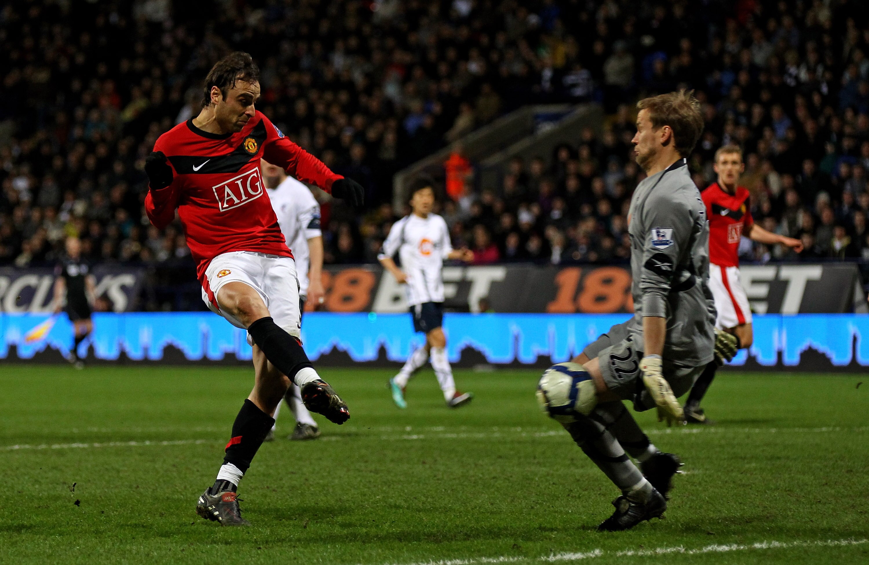 BOLTON, ENGLAND - MARCH 27:  Dimitar Berbatov of Manchester United scores his team's second goal past Jussi Jaaskelainen of Bolton Wanderers during the Barclays Premier League match between Bolton Wanderers and Manchester United at the Reebok Stadium on M