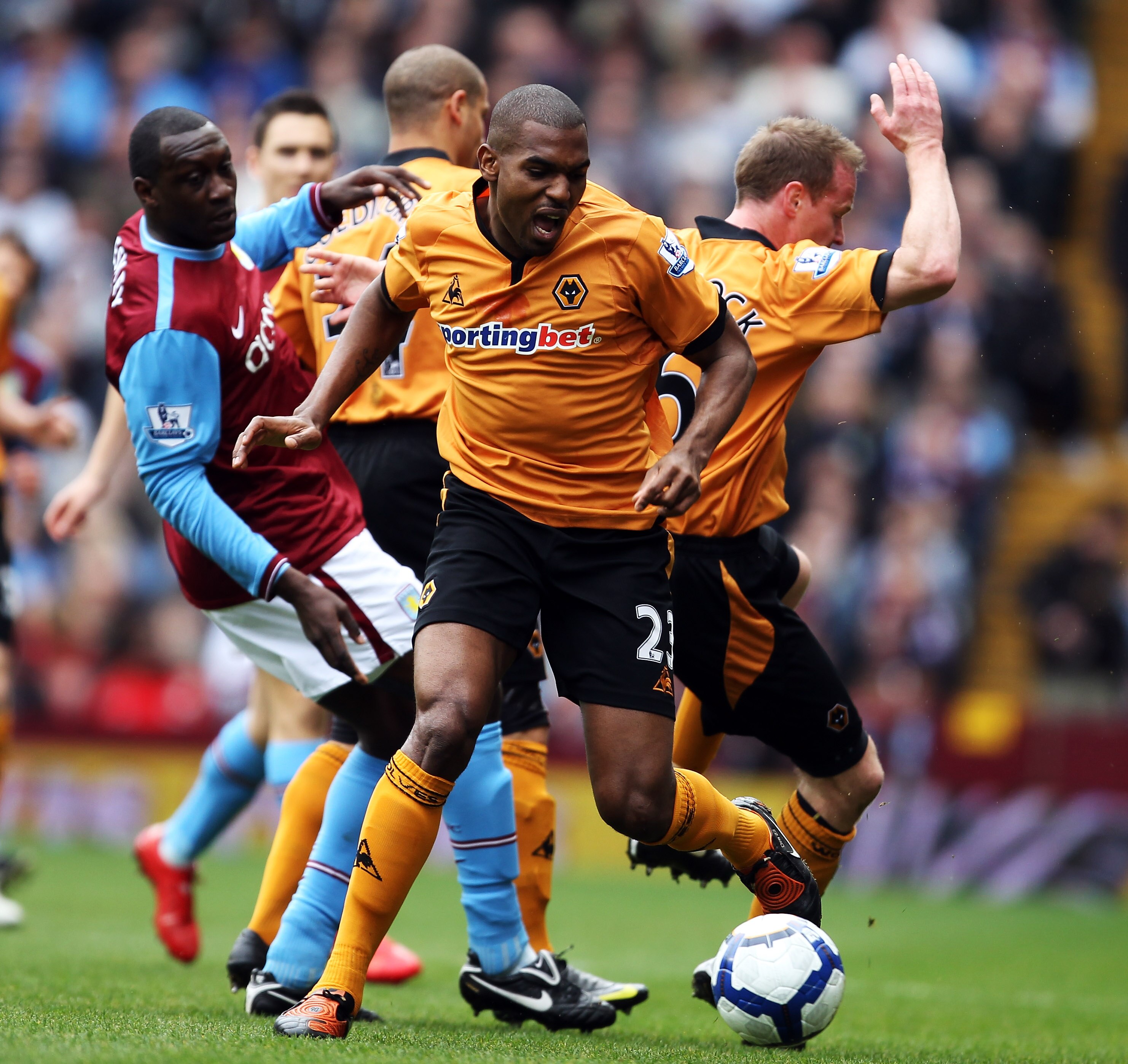 BIRMINGHAM, ENGLAND - MARCH 20: Ronald Zubar of Wolverhampton Wanderers avoids Emile Heskey of Aston Villa during the Barclays Premier League match between Aston Villa and Wolverhampton Wanderers at Villa Park on March 20, 2010 in Birmingham, England.  (P