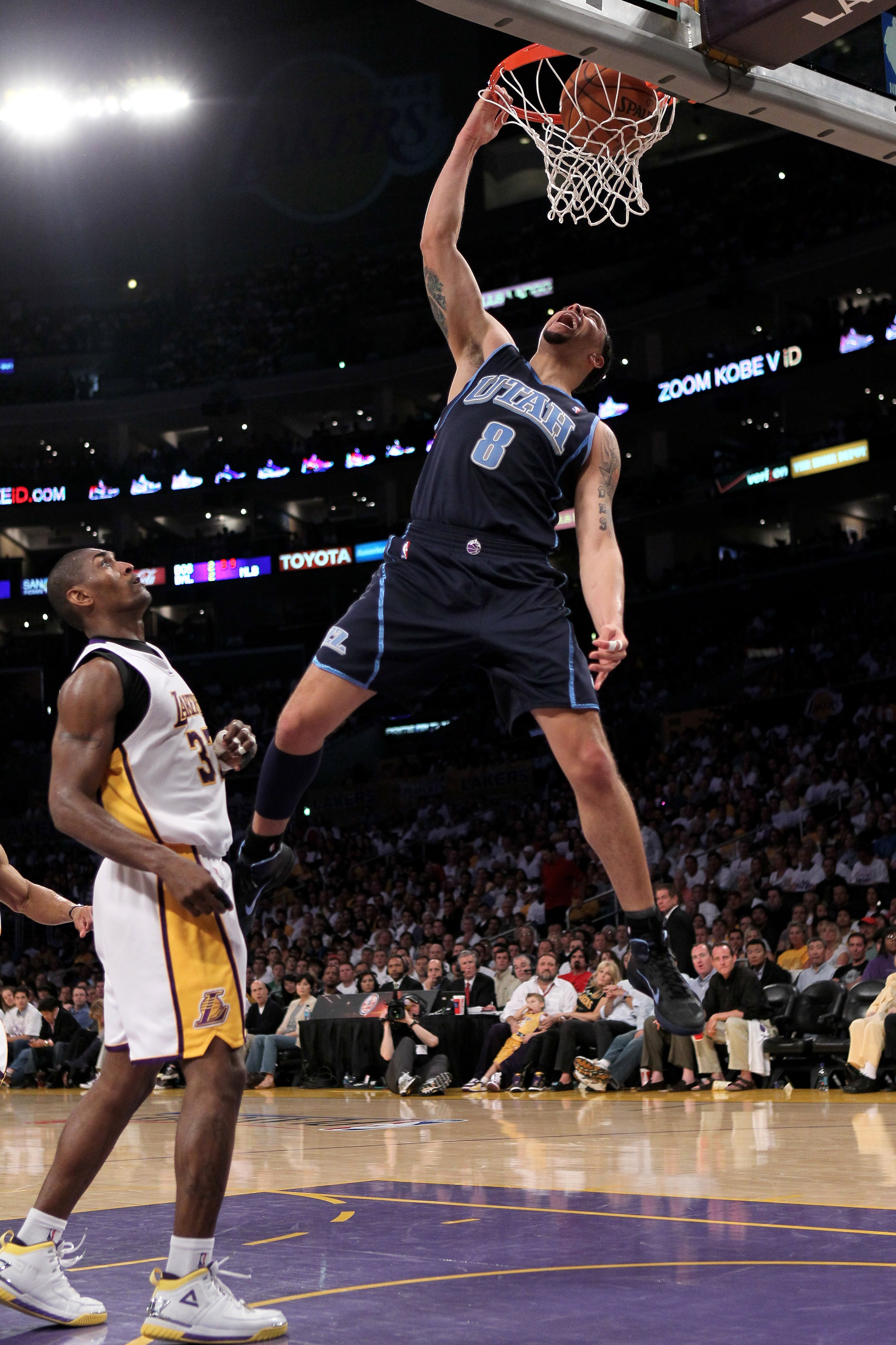 LOS ANGELES, CA - MAY 02:  Deron Williams #8 of the Utah Jazz dunks over Ron Artest #37 of the Los Angeles Lakers during Game One of the Western Conference Semifinals of the 2010 NBA Playoffs on May2, 2010 at Staples Center in Los Angeles, California.  NO