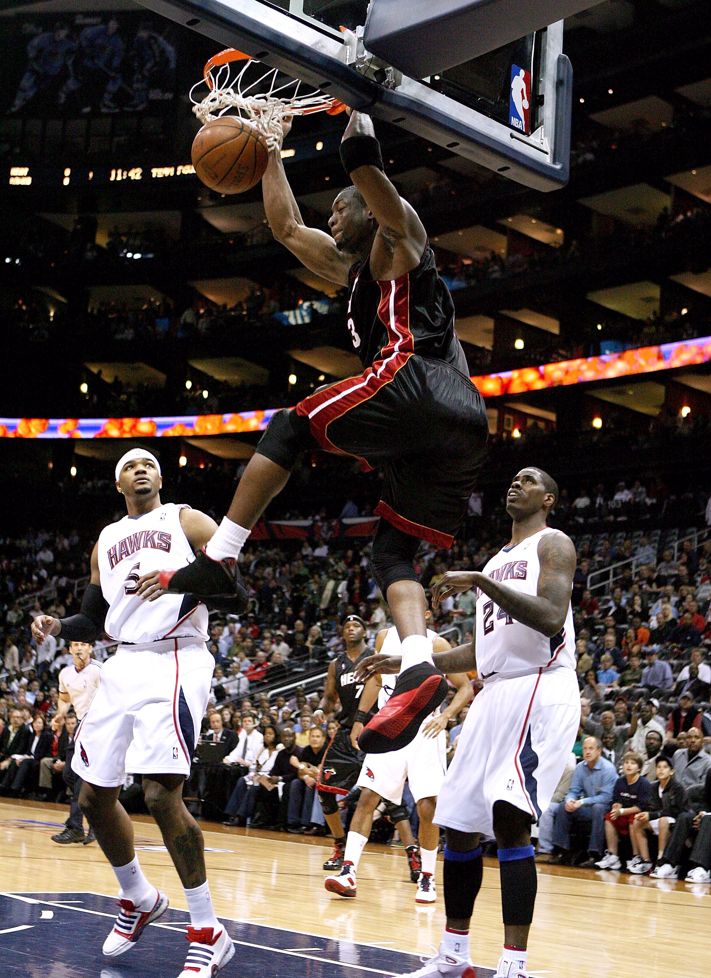 ATLANTA - APRIL 19: Dwyane Wade #3 of the Miami Heat dunks over Josh Smith #5 and Marvin Williams #24 of the Atlanta Hawks during Game One of the First Round of the Eastern Conference Playoffs at Philips Arena on April 19, 2009 in Atlanta, Georgia. NOTE T