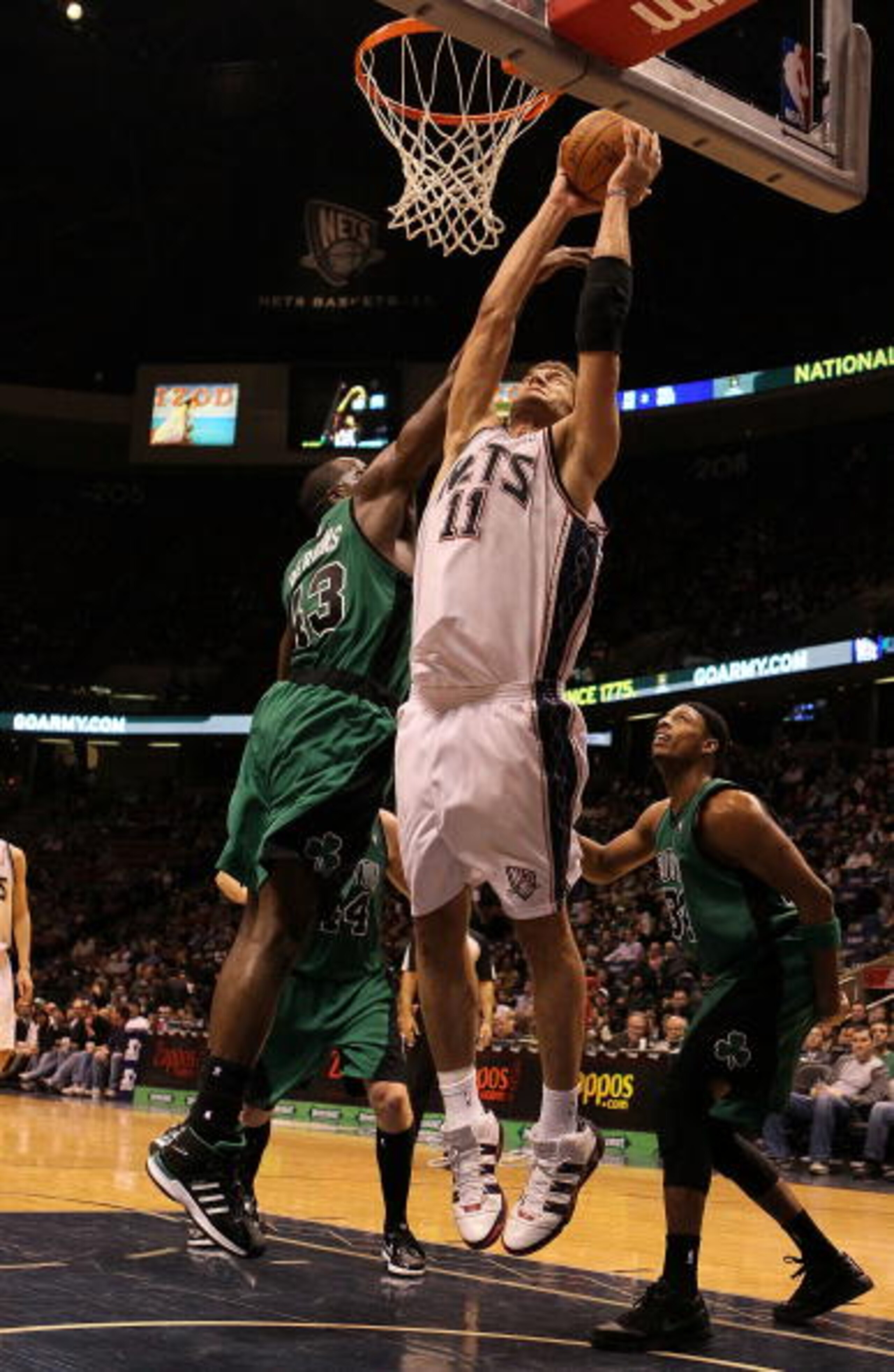 EAST RUTHERFORD, NJ - JANUARY 13:  Brook Lopez #11 of the New Jersey Nets rebounds against Kendrick Perkins #43 of The Boston Celtics during their game on January 13th, 2010 at The Izod Center in East Rutherford, New Jersey. NOTE TO USER: User expressly a