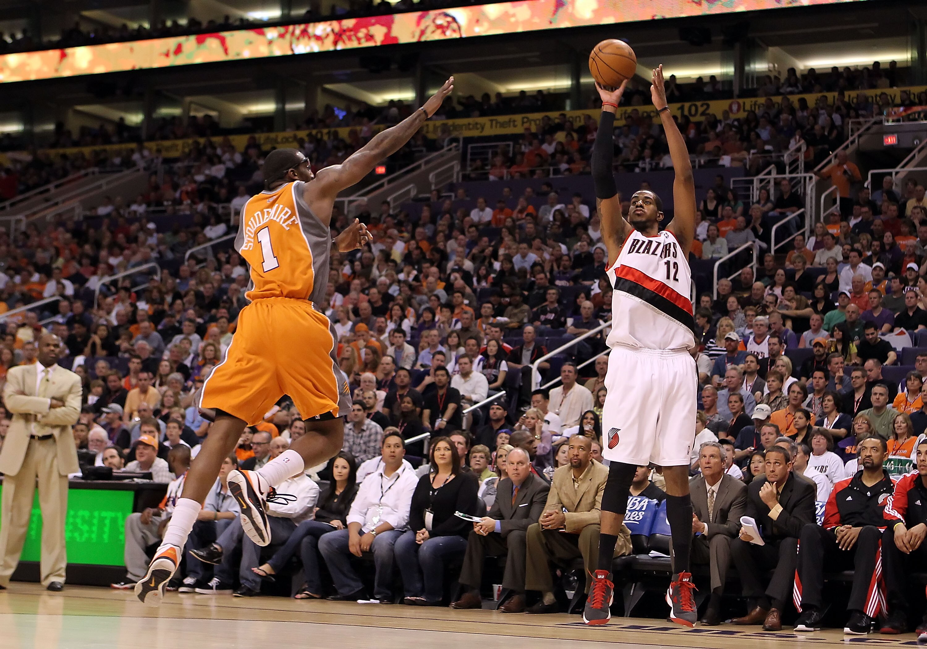 PHOENIX - MARCH 21:  LaMarcus Aldridge #12 of the Portland Trail Blazers puts up a three point shot over Amar'e Stoudemire #1 of the Phoenix Suns during the NBA game at US Airways Center on March 21, 2010 in Phoenix, Arizona. NOTE TO USER: User expressly