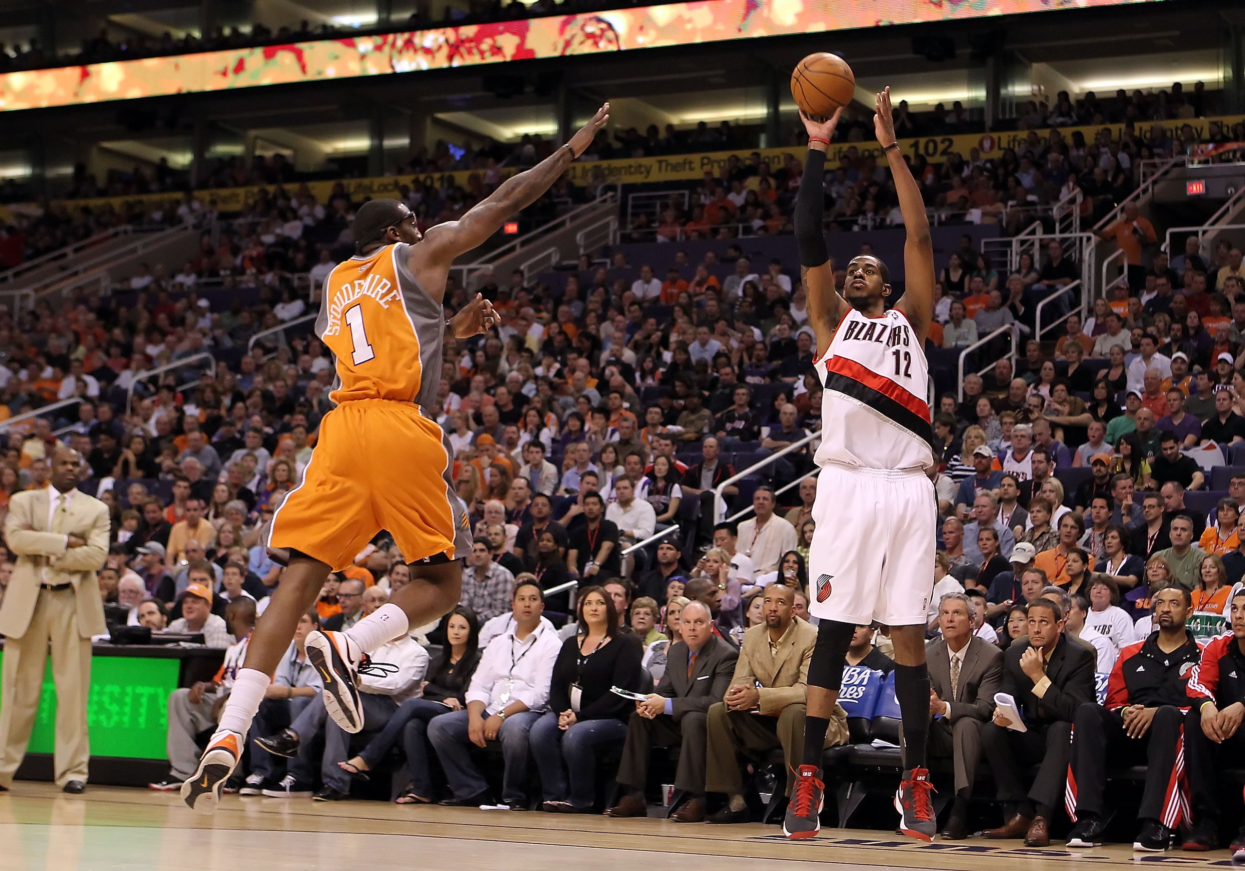 PHOENIX - MARCH 21:  LaMarcus Aldridge #12 of the Portland Trail Blazers puts up a three point shot over Amar'e Stoudemire #1 of the Phoenix Suns during the NBA game at US Airways Center on March 21, 2010 in Phoenix, Arizona. NOTE TO USER: User expressly