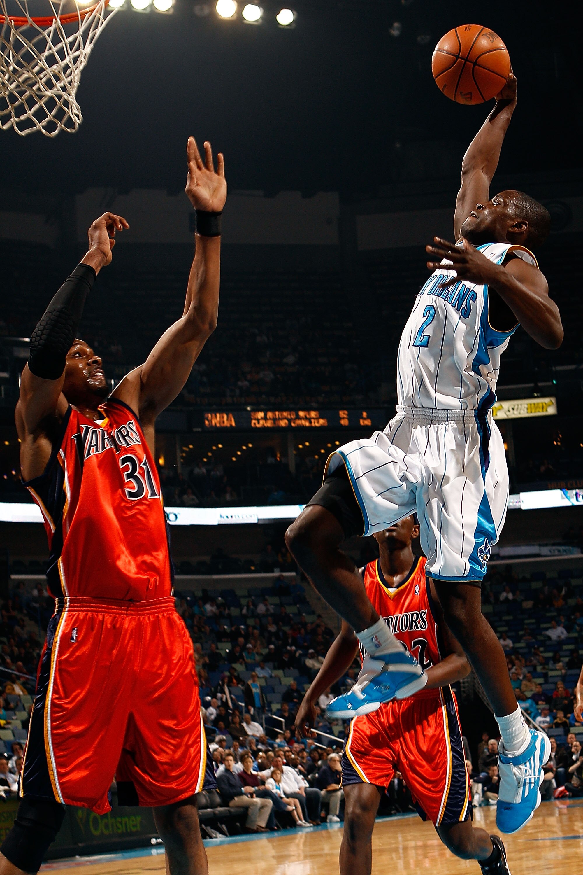 NEW ORLEANS - MARCH 08:  Darren Collison #2 of the New Orleans Hornets tries to dunk the ball over Chris Hunter #31 of the Golden State Warriors at New Orleans Arena on March 8, 2010 in New Orleans, Louisiana.  NOTE TO USER: User expressly acknowledges an