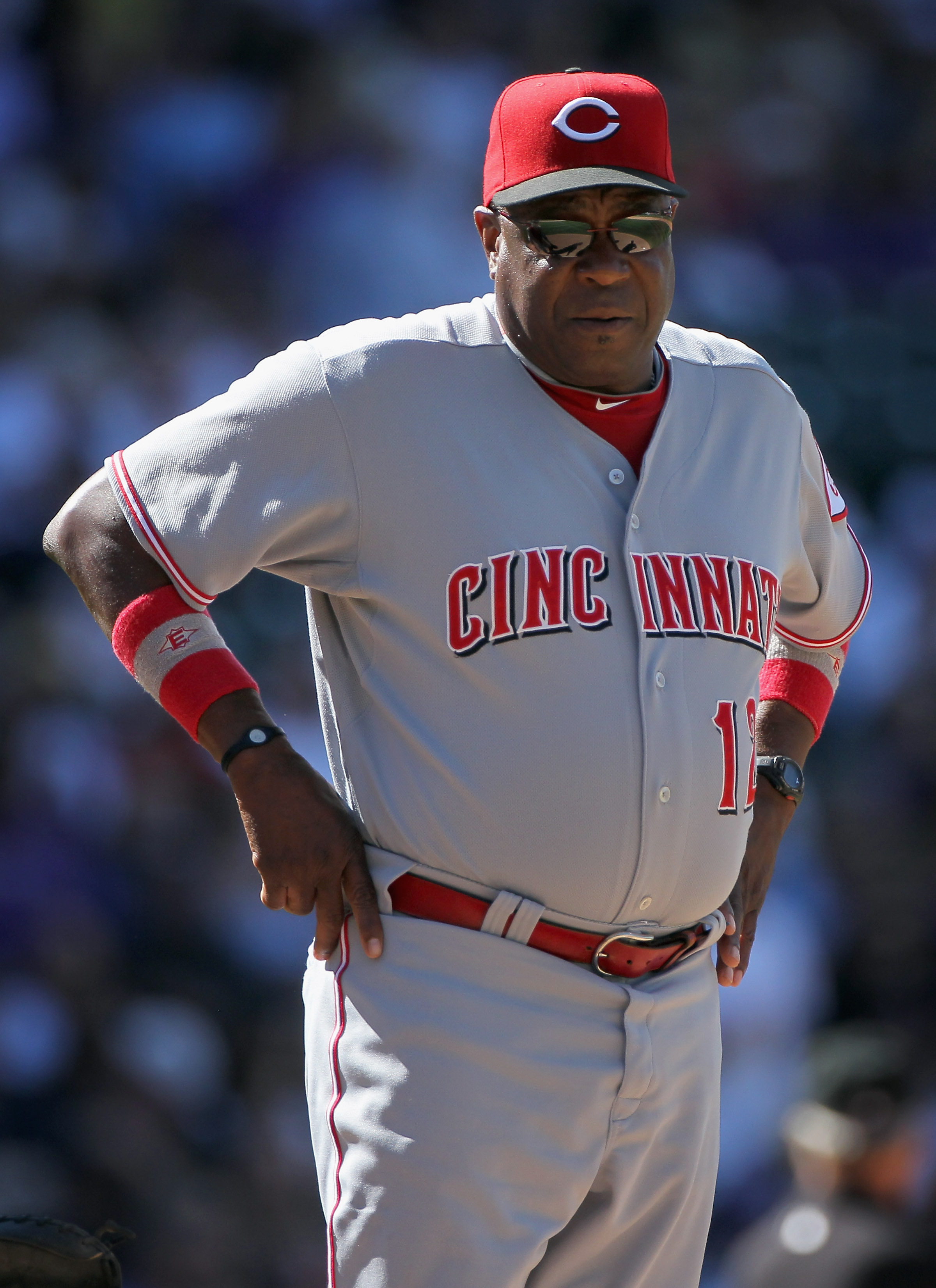 DENVER - SEPTEMBER 09:  Manager Dusty Baker #12 heads top the mound to remove starting pitcher Travis Wood of the Cincinnati Reds against the Colorado Rockie at Coors Field on September 9, 2010 in Denver, Colorado. The Rockies defeated the Reds 6-5.  (Pho