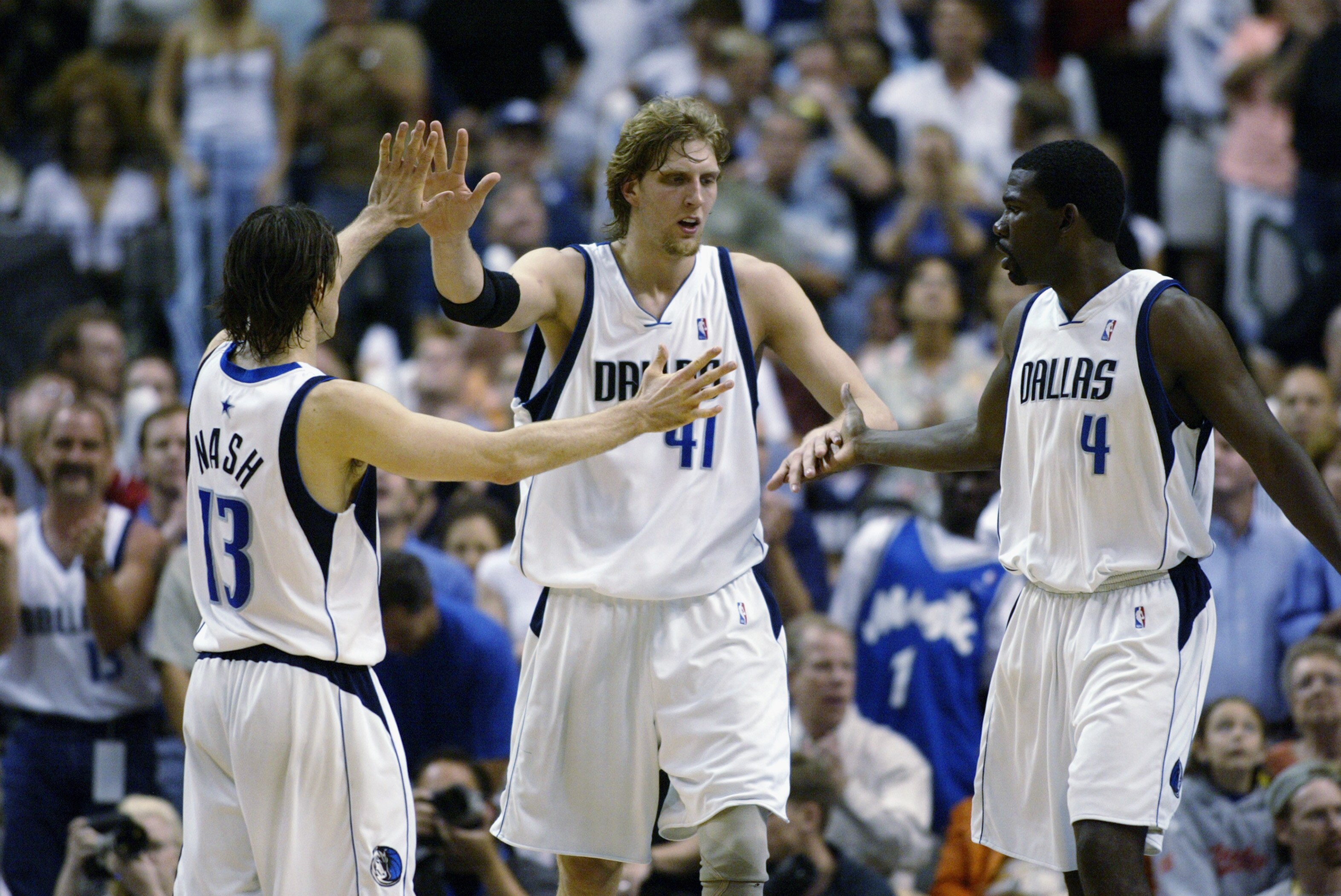 DALLAS - MAY 4:  (Left to Right) Steve Nash #13, Dirk Nowitzki #41, and Michael Finley #4 of the Dallas Mavericks celebrate in Game seven of the Western Conference Quarterfinals against the Portland Trail Blazers during the 2003 NBA Playoffs at American A