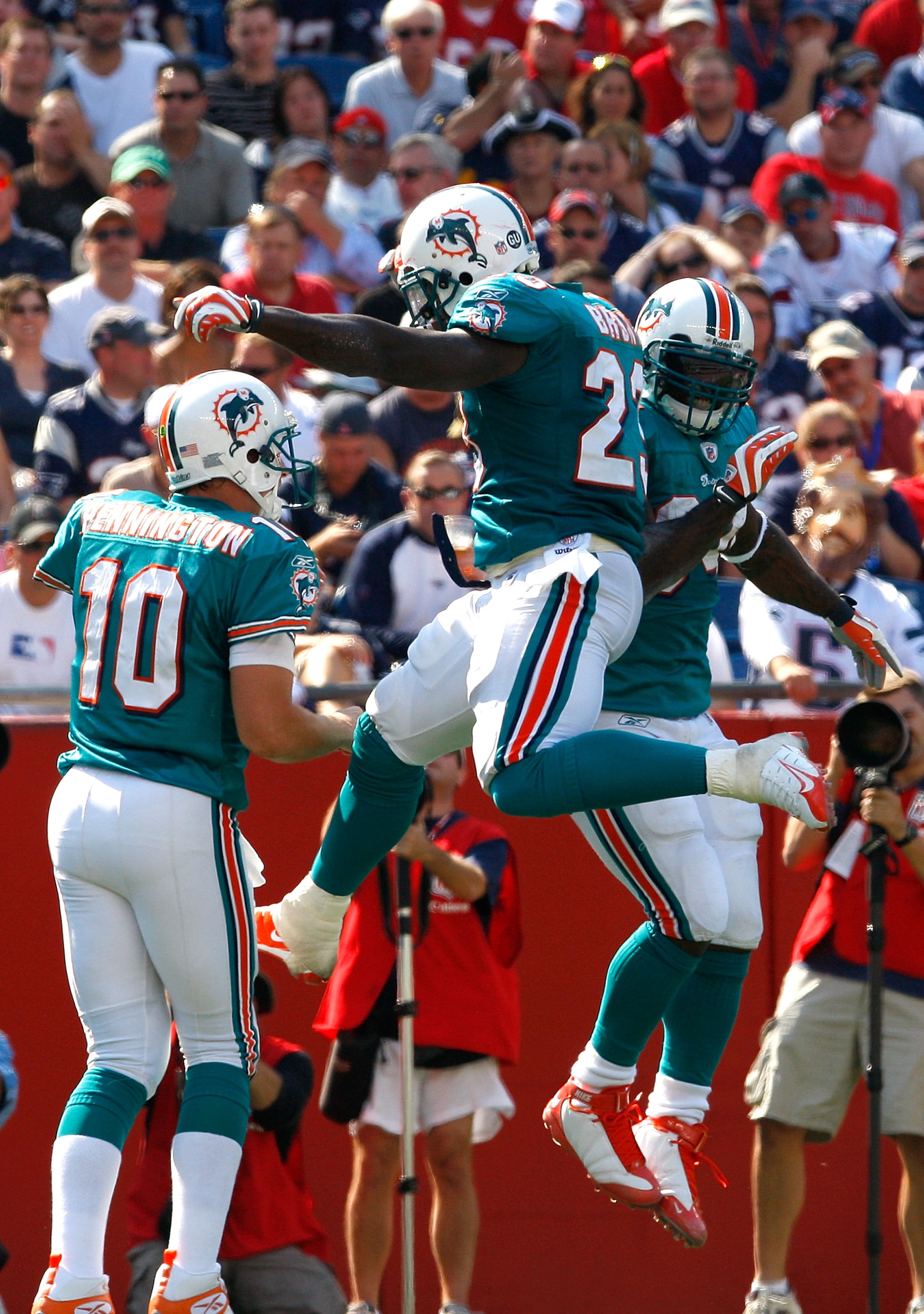 FOXBORO, MA - SEPTEMBER 21: Ronnie Brown #23 of the Miami Dolphins celebrates his touchdown with teammates Chad Pennington #10 and Ricky Williams #34 against the New England Patriots at Gillette Stadium on September 21, 2008 in Foxboro, Massachusetts. The