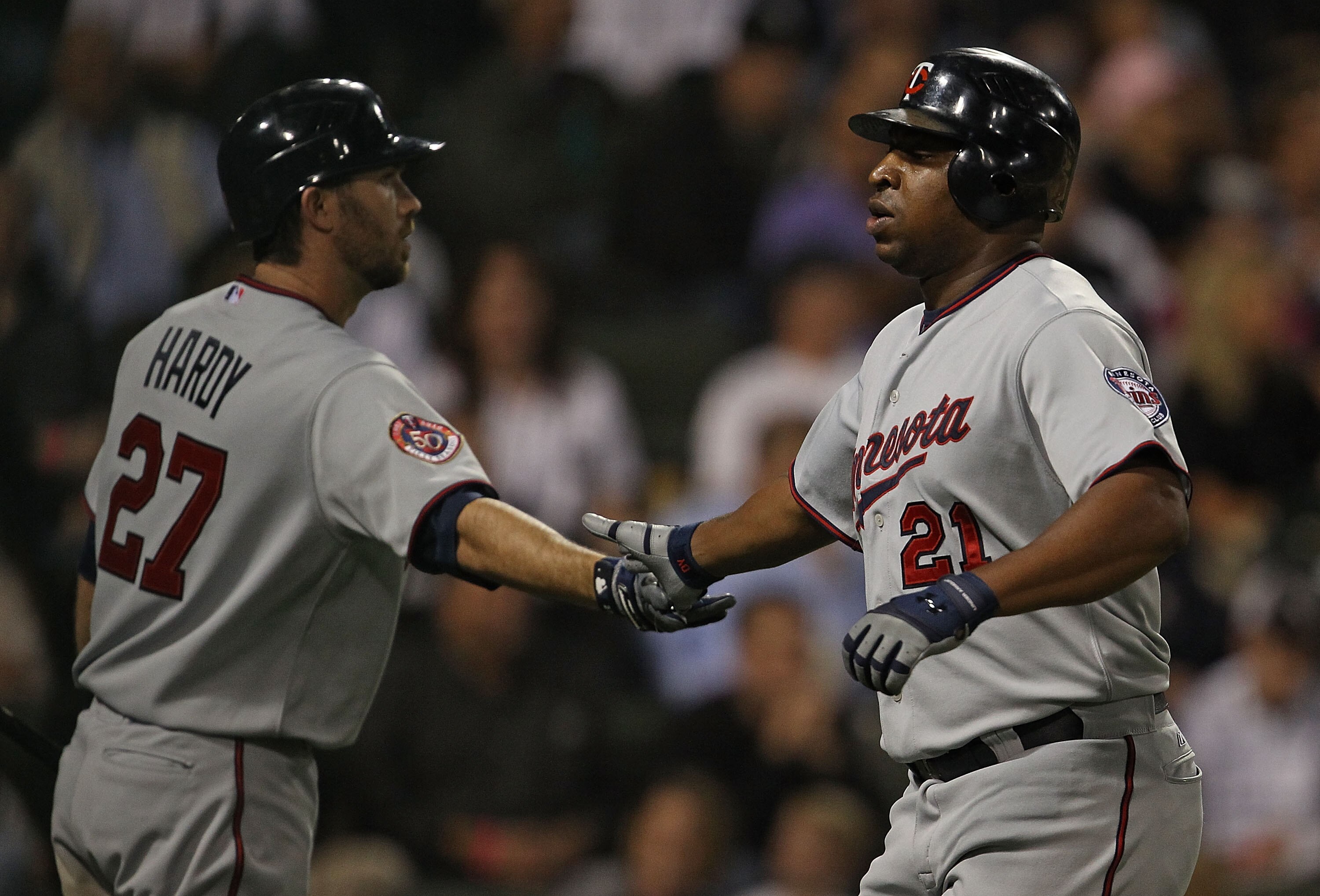 CHICAGO - SEPTEMBER 14: Delmon Young #21 of the Minnesota Twins is congratulated by teammate J.J. Hardy #27 after scoring a run in the 7th inning against the Chicago White Sox at U.S. Cellular Field on September 14, 2010 in Chicago, Illinois. (Photo by Jo