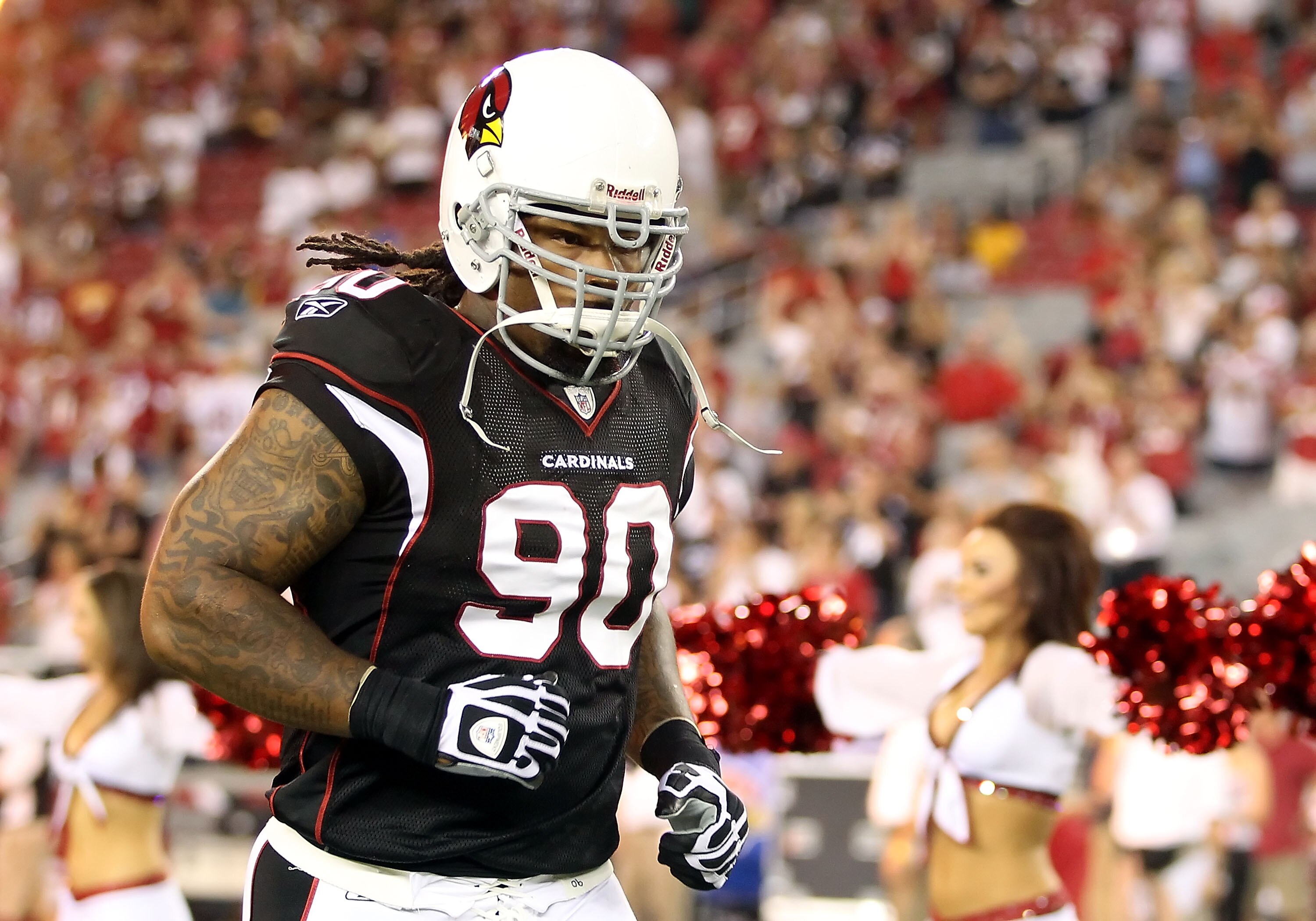 GLENDALE, AZ - SEPTEMBER 02:  Defensive tackle Darnell Dockett #90 of the Arizona Cardinals runs onto the field before the preseason NFL game against the Washington Redskins at the University of Phoenix Stadium on September 2, 2010 in Glendale, Arizona.