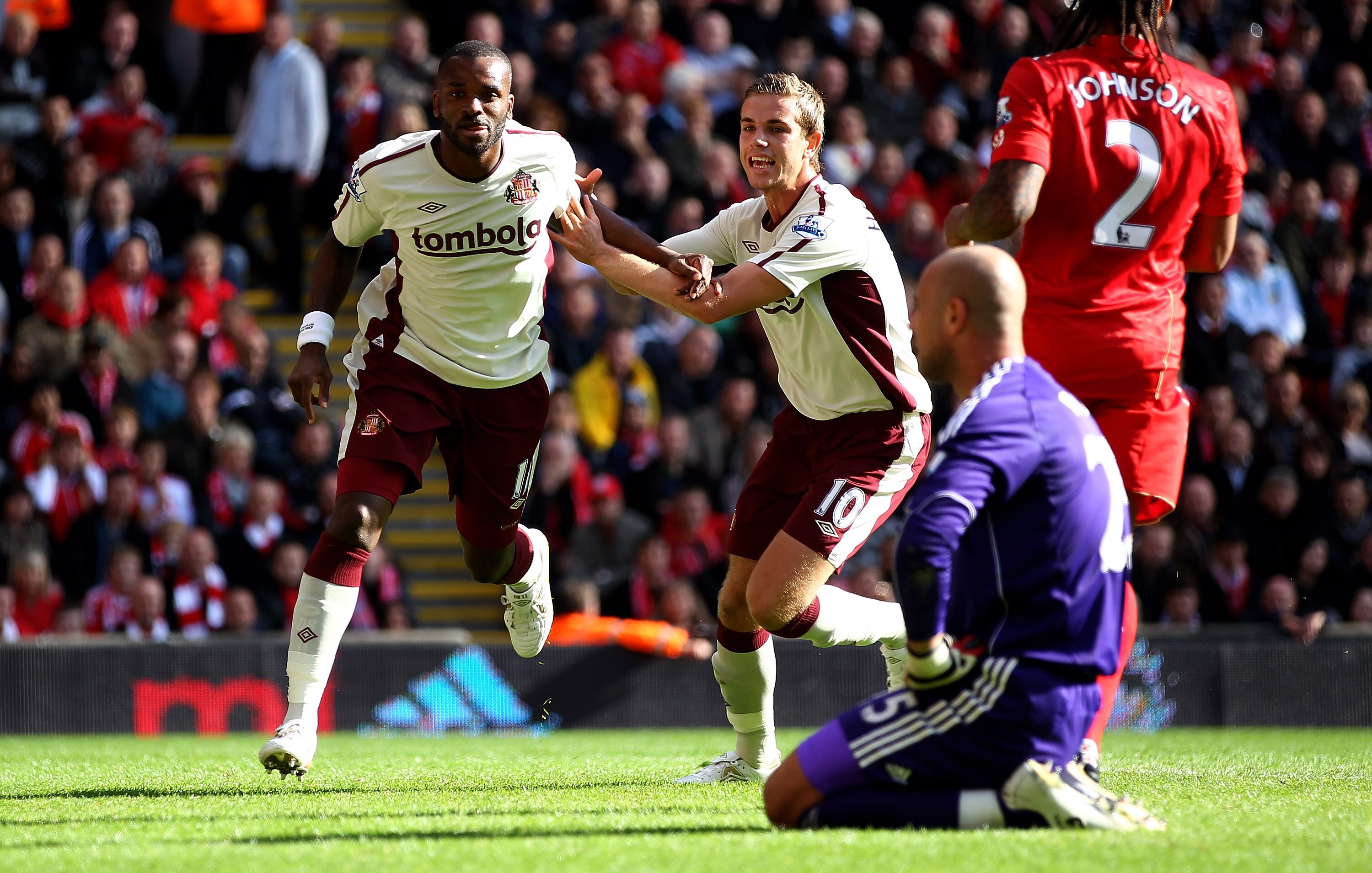 LIVERPOOL, ENGLAND - SEPTEMBER 25:  Darren Bent of Sunderland celebrates with team mate Jordan Henderson after scoring the equalizer from the penalty spot as Liverpool keeper Pepe Reina looks on during the Barclays Premier League match between Liverpool a