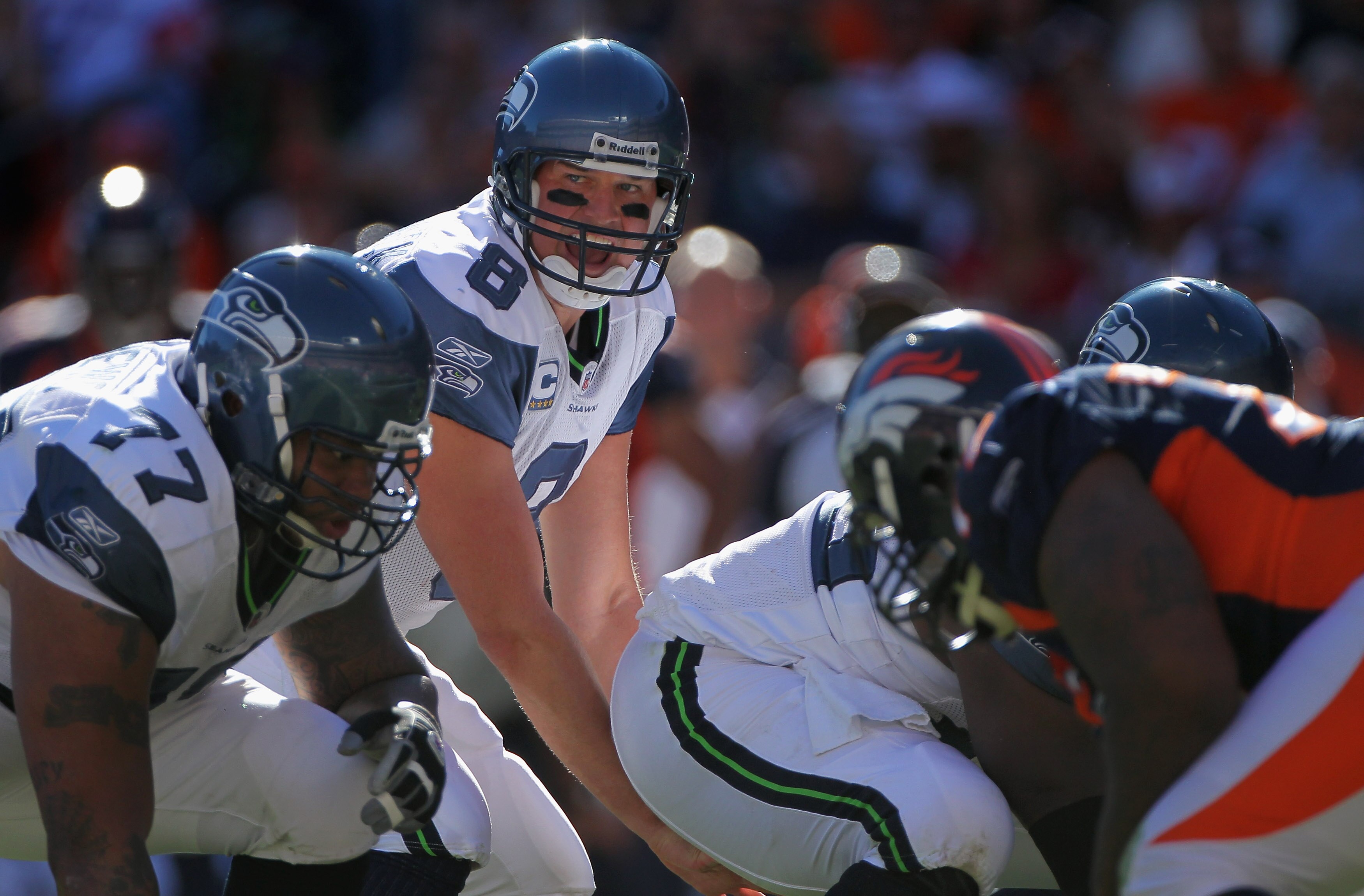 DENVER - SEPTEMBER 19:  Quarterback Matt Hasselbeck #8 of the Seattle Seahawks prepares to take the snap from center Chris Spencer #65 against the Denver Broncos at INVESCO Field at Mile High on September 19, 2010 in Denver, Colorado. The Broncos defeated