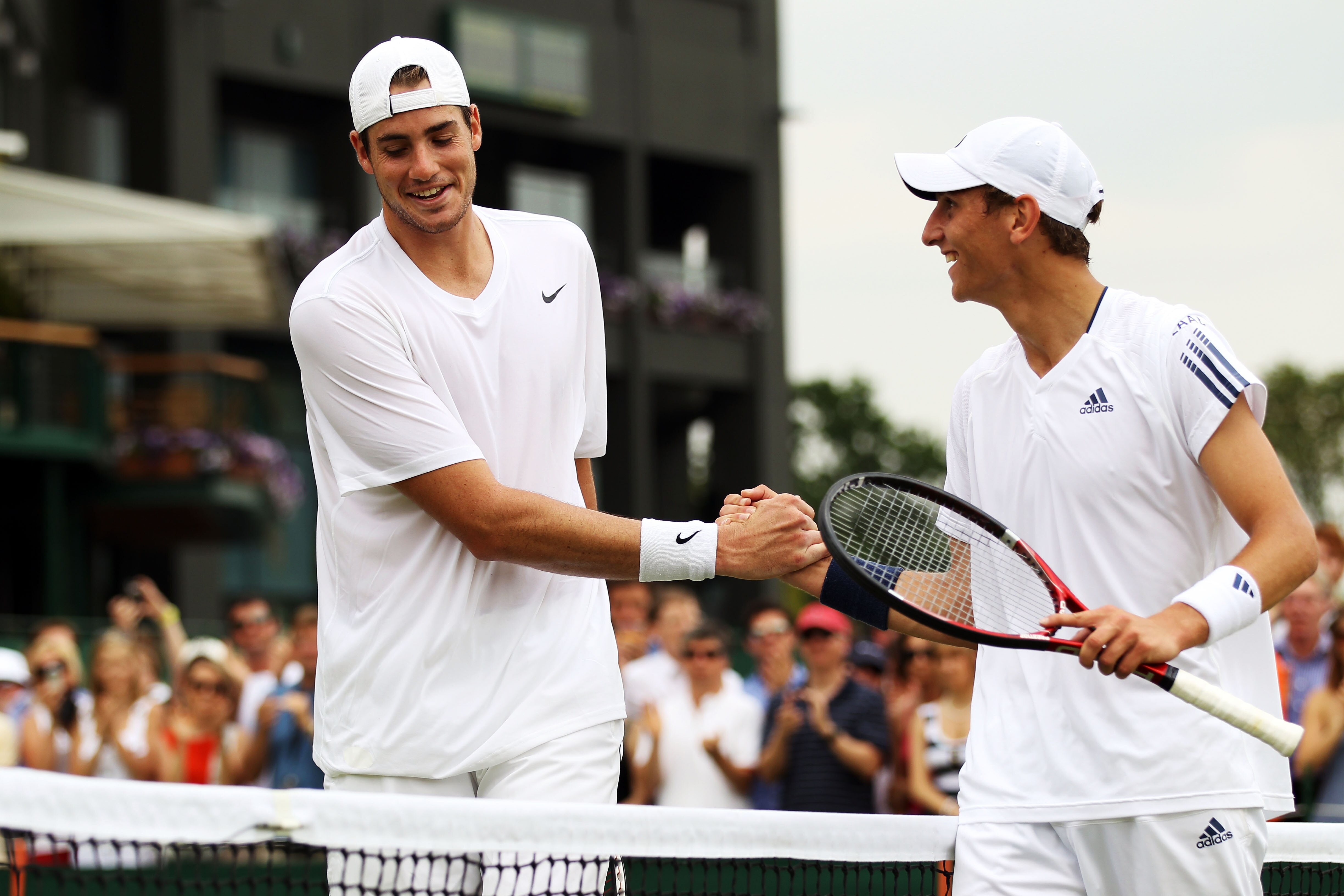 LONDON, ENGLAND - JUNE 25:  John Isner of USA (L) smiles after losing his match against Thiemo De Bakker (R) of Netherlands on Day Five of the Wimbledon Lawn Tennis Championships at the All England Lawn Tennis and Croquet Club on June 25, 2010 in London,