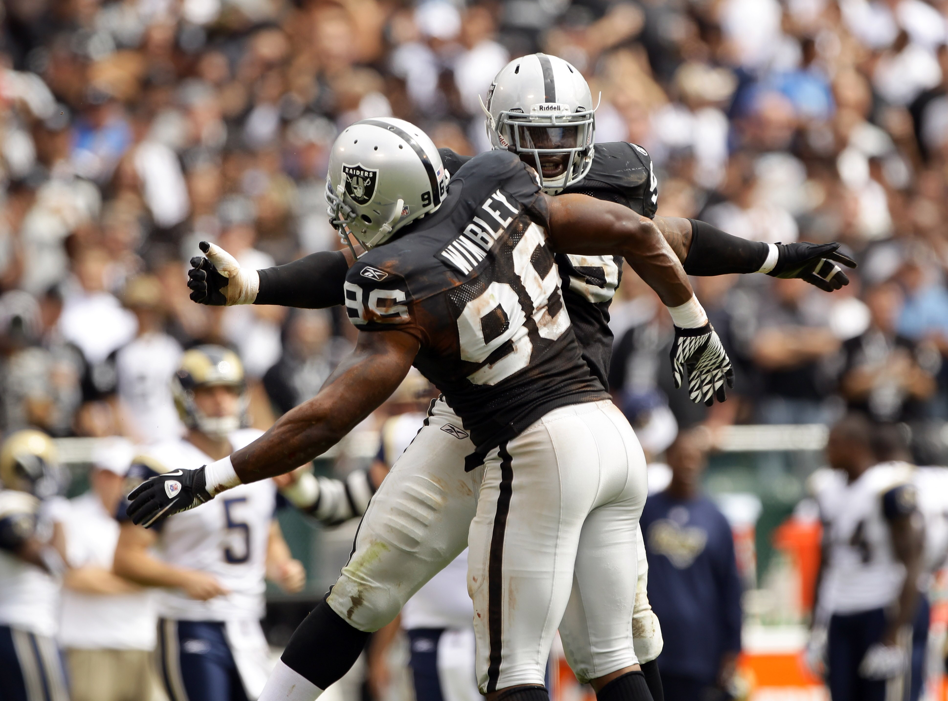 OAKLAND, CA - SEPTEMBER 19:  Lamarr Houston #99 is congratulated by Kamerion Wimbley #96 of the Oakland Raiders after Houston sacked Sam Bradford #8 of the St. Louis Rams at the Oakland-Alameda County Coliseum on September 19, 2010 in Oakland, California.