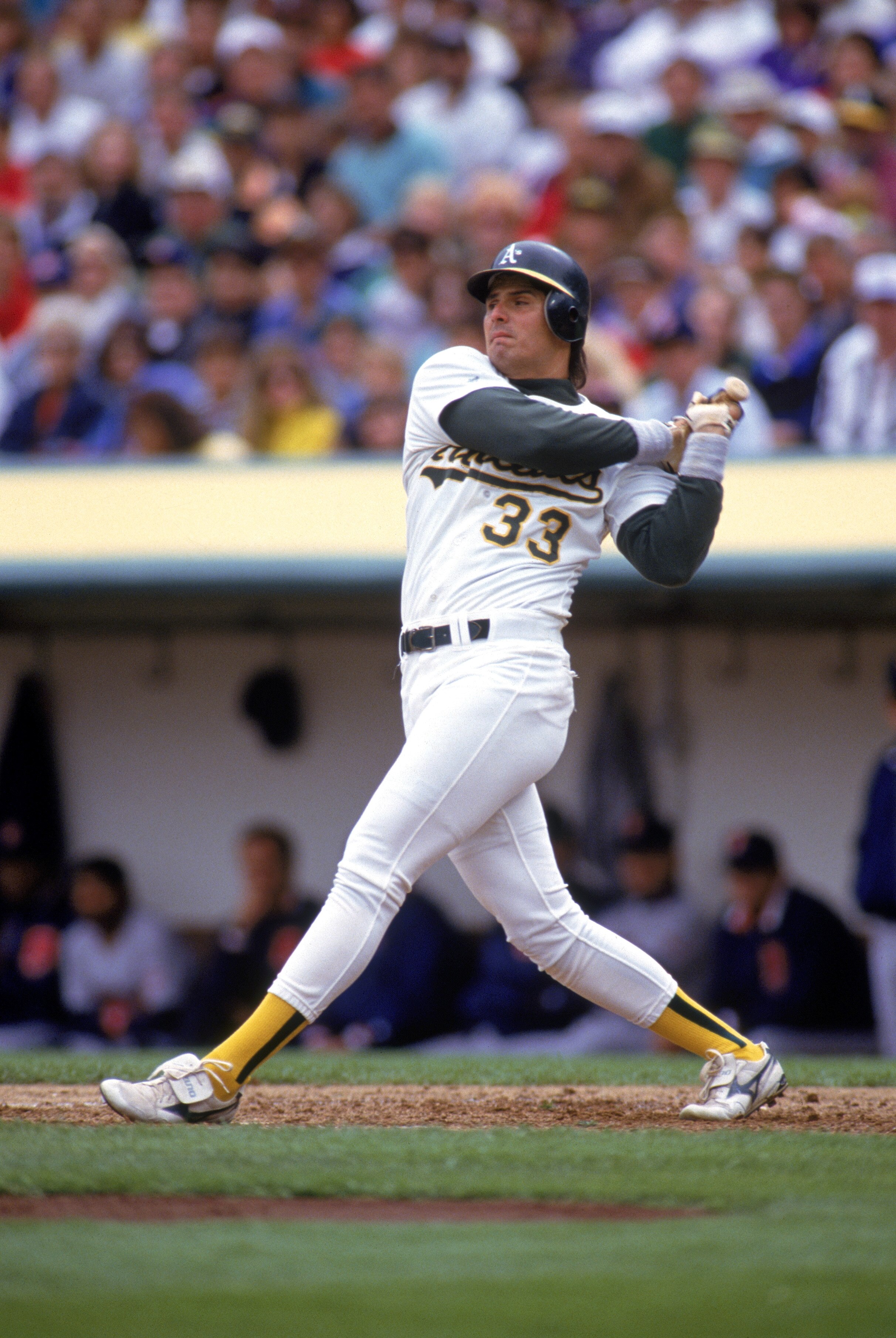 OAKLAND, CA - 1991:  Jose Canseco #33 of the Oakland Athletics watches the flight of the ball as he follows through on a swing during a 1991 MLB season game against the Minnesota Twins at Oakland-Alameda County Coliseum in Oakland, California.  (Photo by