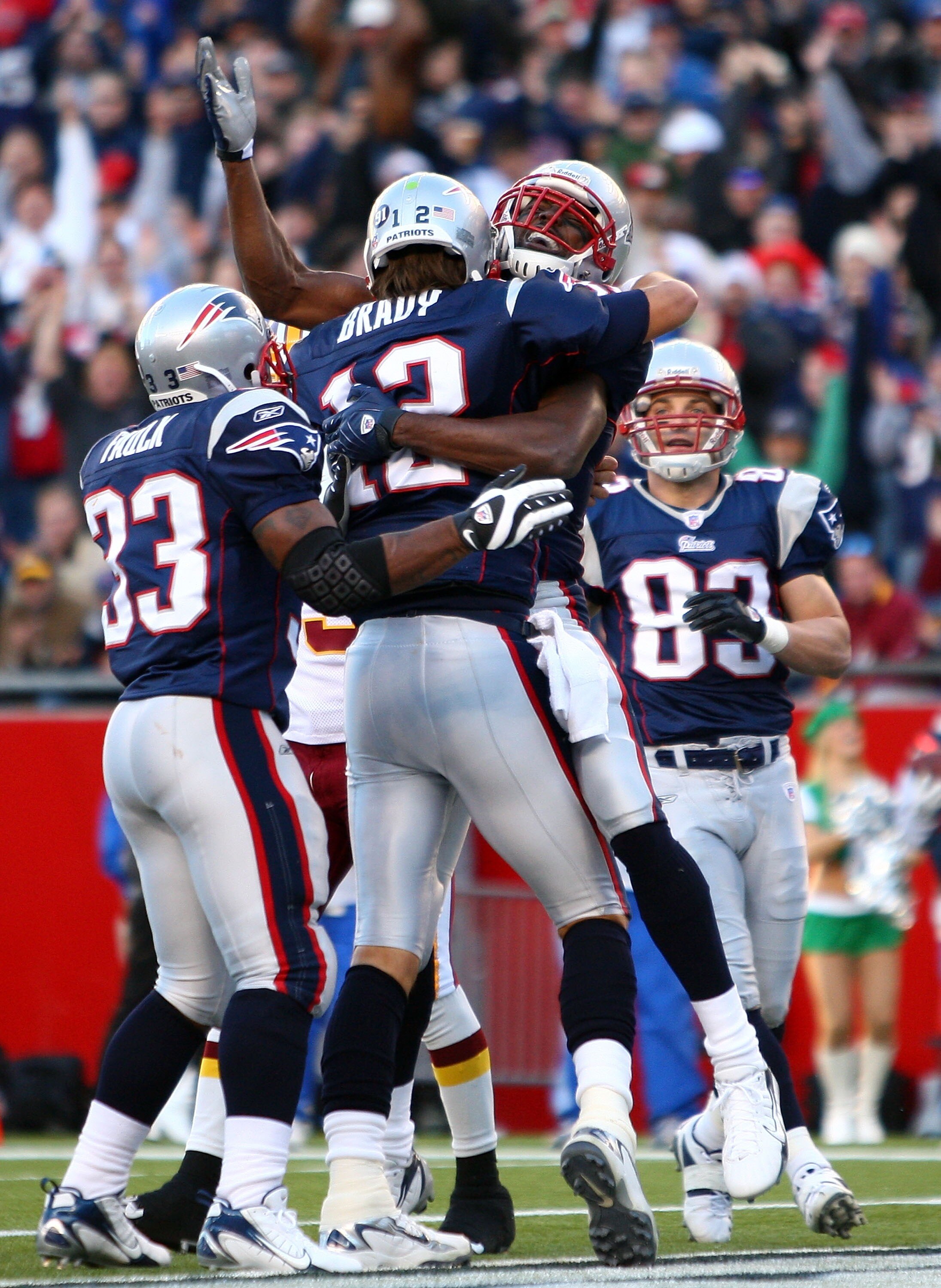 FOXBORO, MA - OCTOBER 28:  Randy Moss #81, Kevin Faulk #33 and Wes Walker #83 of the New England Patriots congratulate Tom Brady #12 after Brady ran the ball in for a touchdown in the first quarter against the Washington Redskins at Gillette Stadium Octob