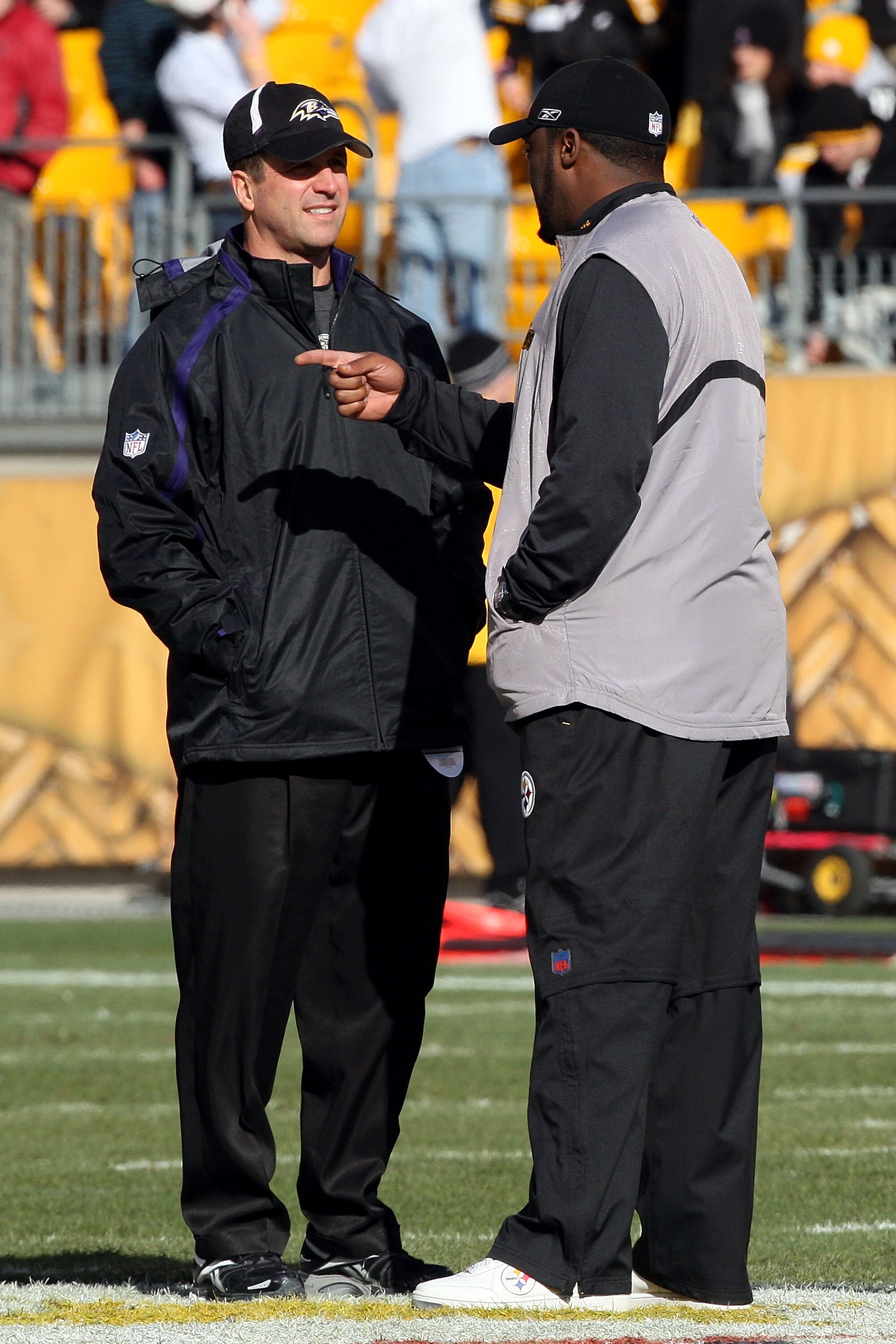 PITTSBURGH - DECEMBER 27:  Head coach John Harbaugh (L) of the Baltimore Ravens and head coach Mike Tomlin of the Pittsburgh Steelers meet at midfield before the game at Heinz Field on December 27, 2009 in Pittsburgh, Pennsylvania.  (Photo by Karl Walter/