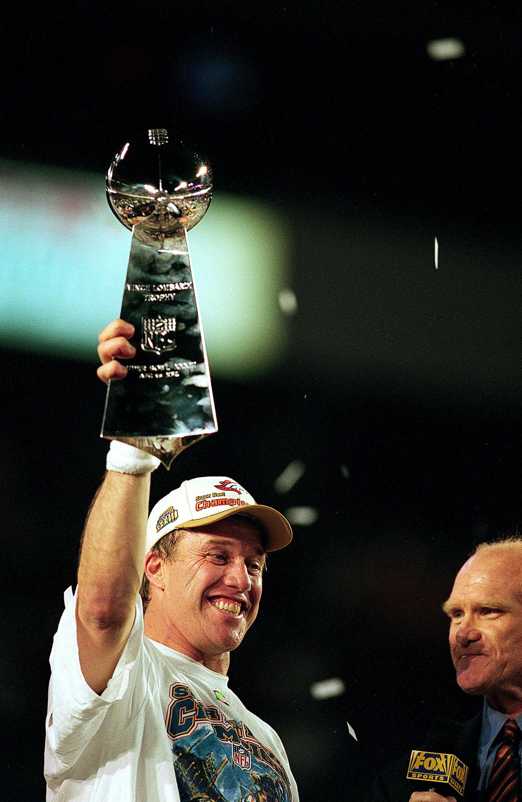 31 Jan 1999:   John Elway #7 of the Denver Broncos holds up the trophy after the Superbowl XXXIII against the Atlanta Falcons at the Pro Player Stadium in Miami, Florida. The Broncos defeated the Falcons 34-19. Mandatory Credit: Andy Lyons  /Allsport